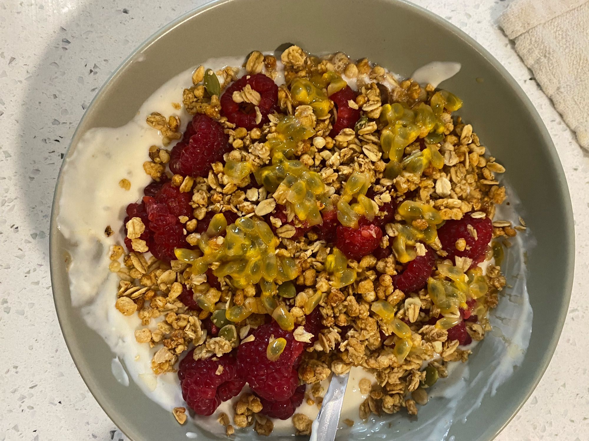 Plant based yogurt with raspberries, granola and passion fruit