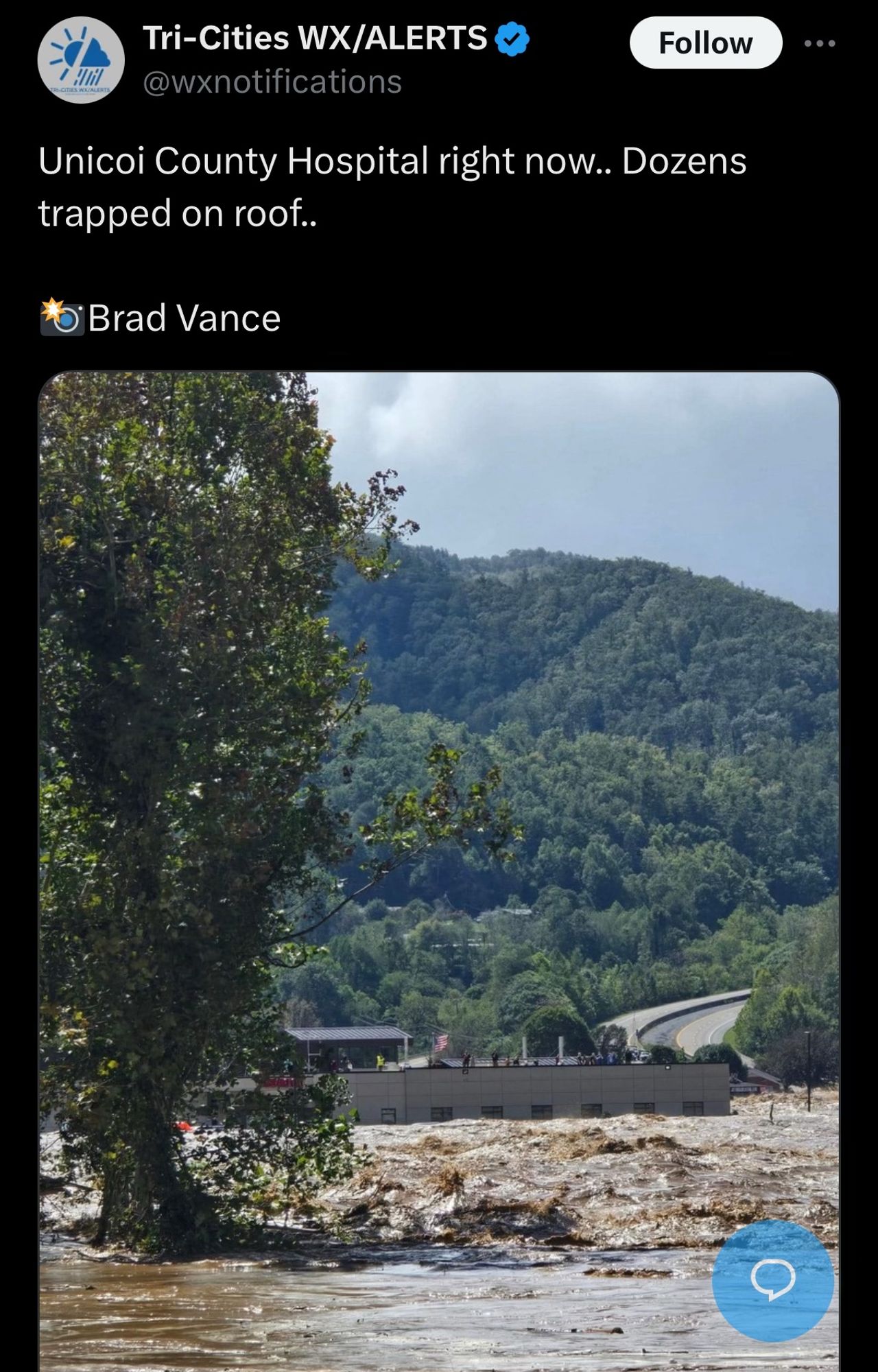 Screenshot of twitter post from Tri-Cities WX alerts. There is a picture of flood waters reaching the roof of Unicoi County Hospital in Tennessee