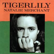 Album cover for Tigerlily by Natalie Merchant.

In the center is a black and white photo of a young woman with a hand obscuring her mouth and chin.  Behind the photo, the bottom 2/3 of the cover is green, while the top 1/3 is orange.