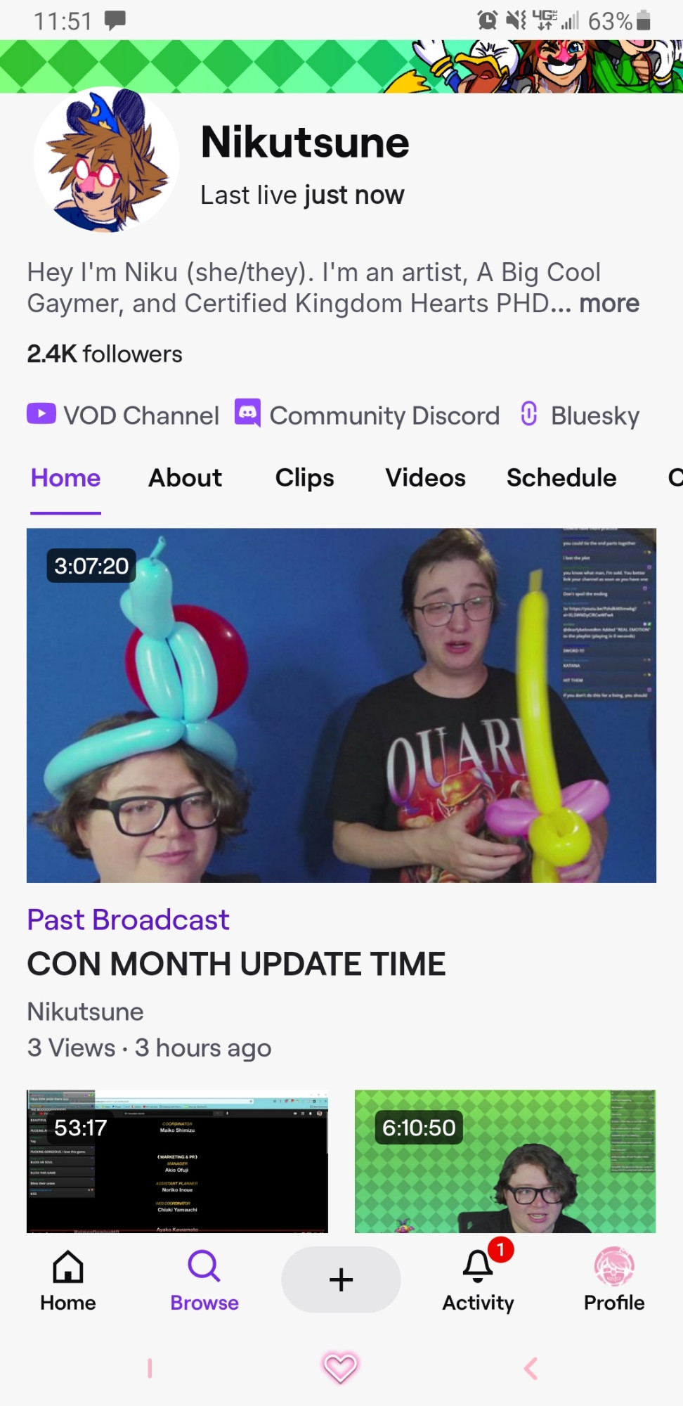A screenshot of me in my quark shirt next to my partner holding a half formed balloon wand. 