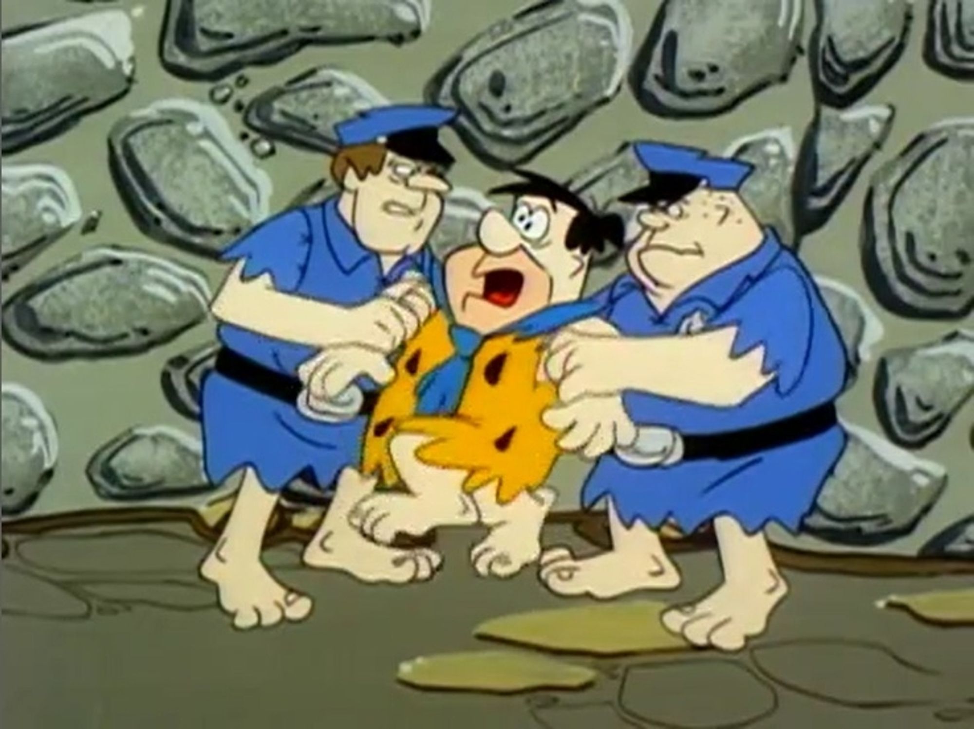 Still from The Flintstones - Fred's Last Resort.

Fred is arrested by two Bedrock Policemen.