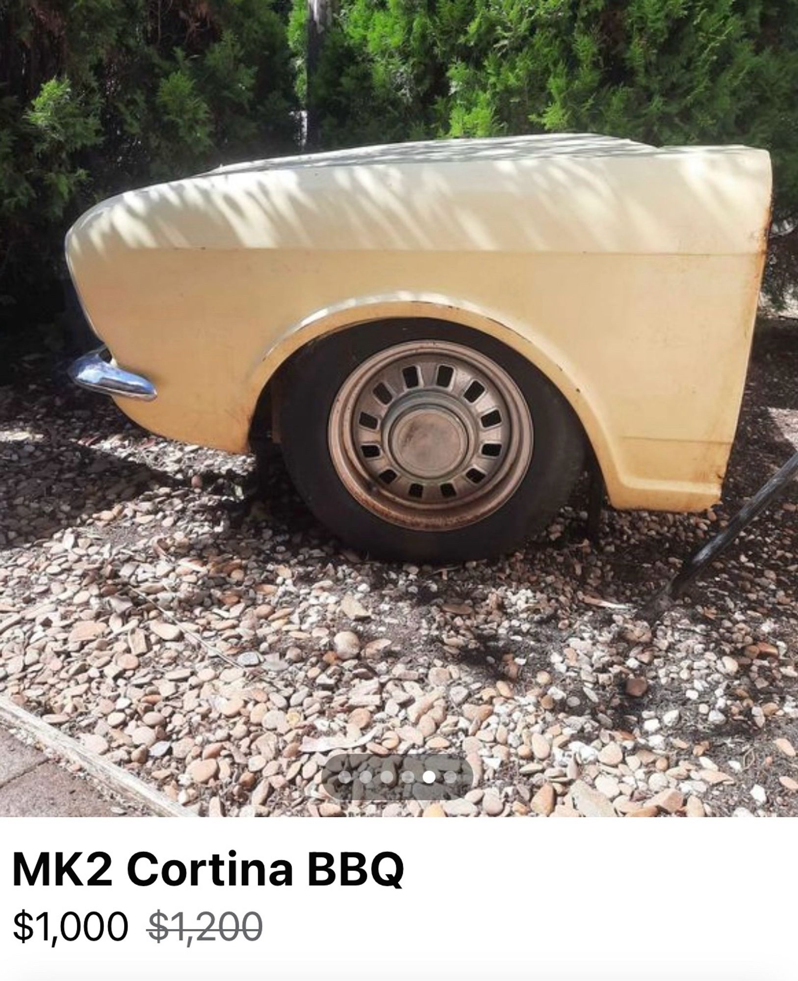 The front end of an old Ford Cortina that has been neatly sawn off the body of the car – lifting the bonnet reveals a BBQ where the motor should be