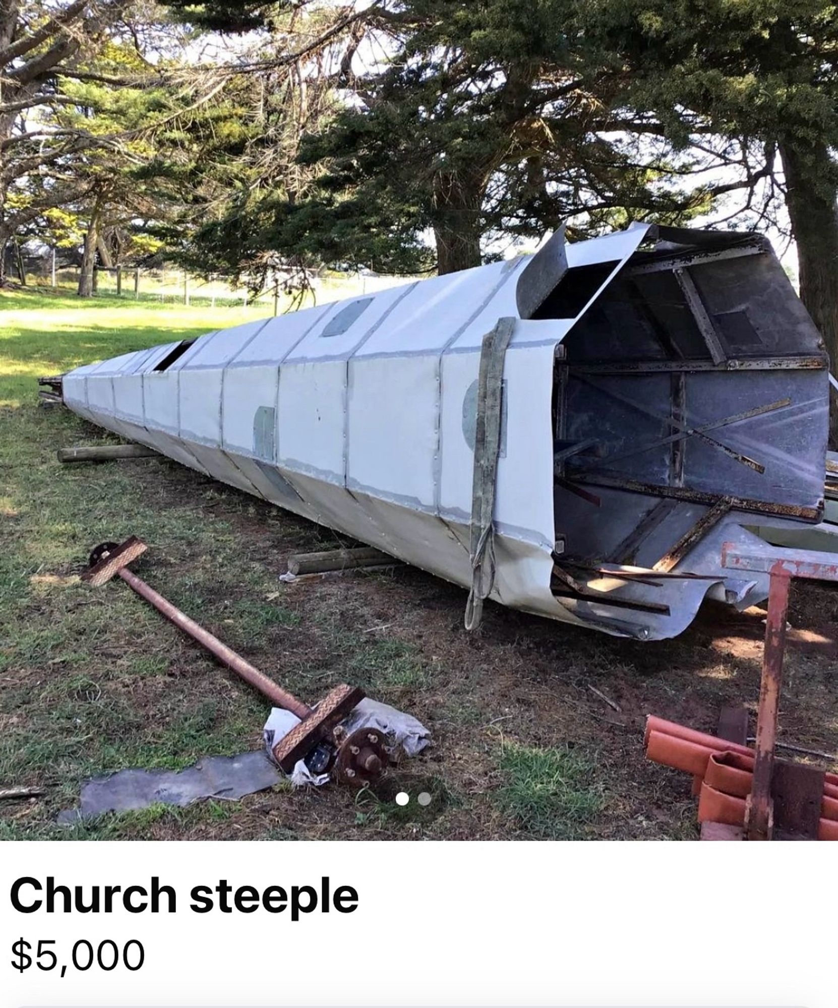 A church steeple lying on its side in a paddock