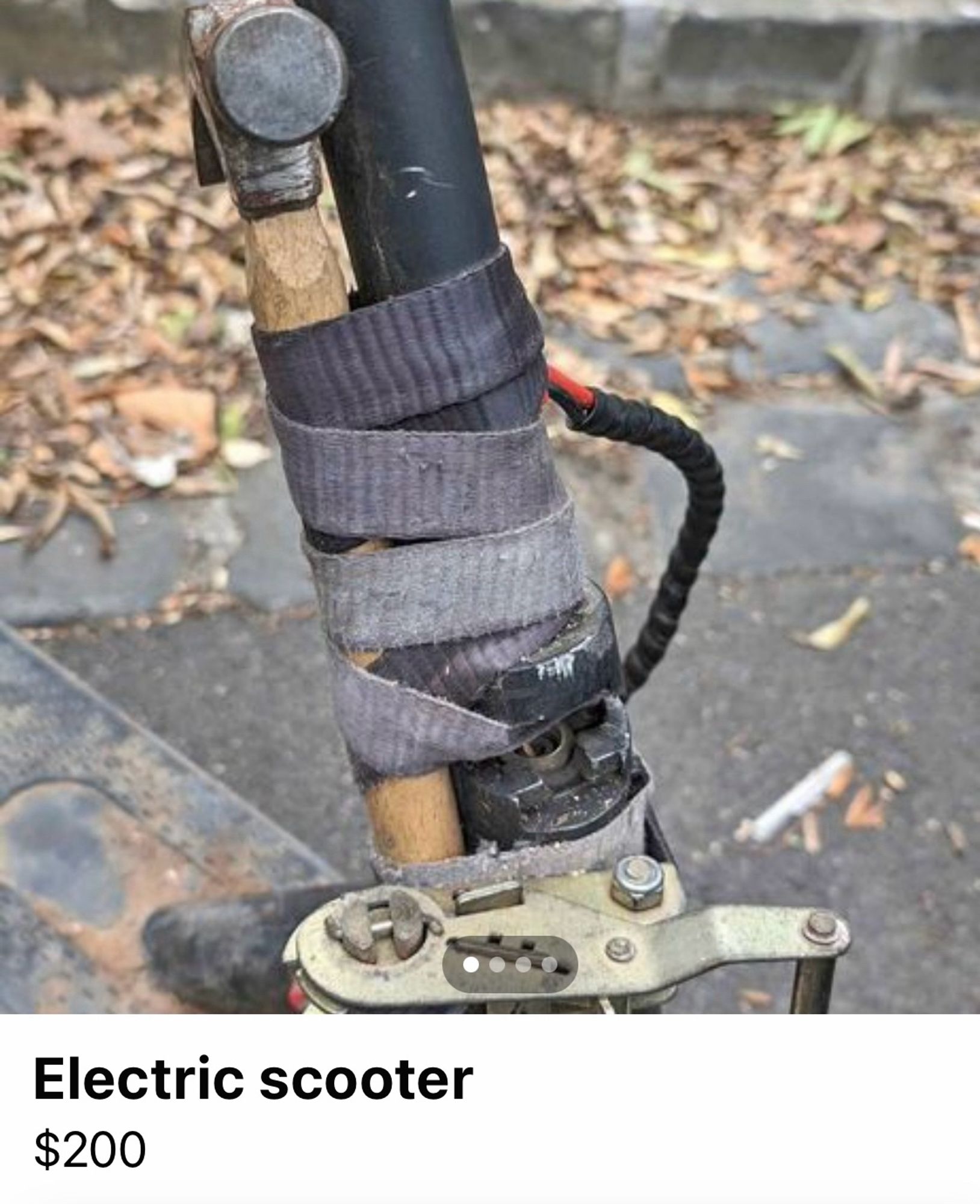 An electric scooter which has been repaired by strapping a claw hammer to the front shaft with a bit of cloth tape