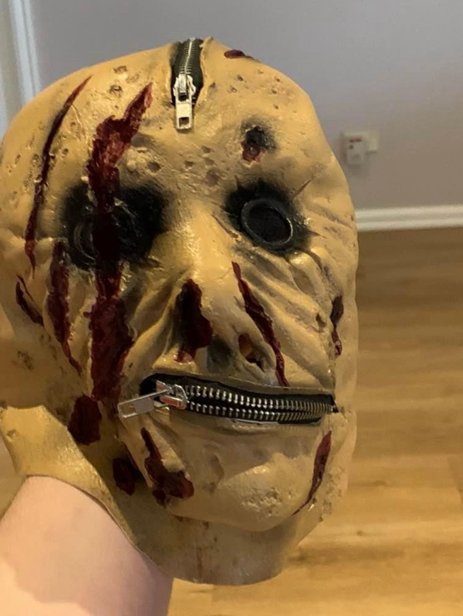 Scary Halloween mask with a zip where the mouth should be