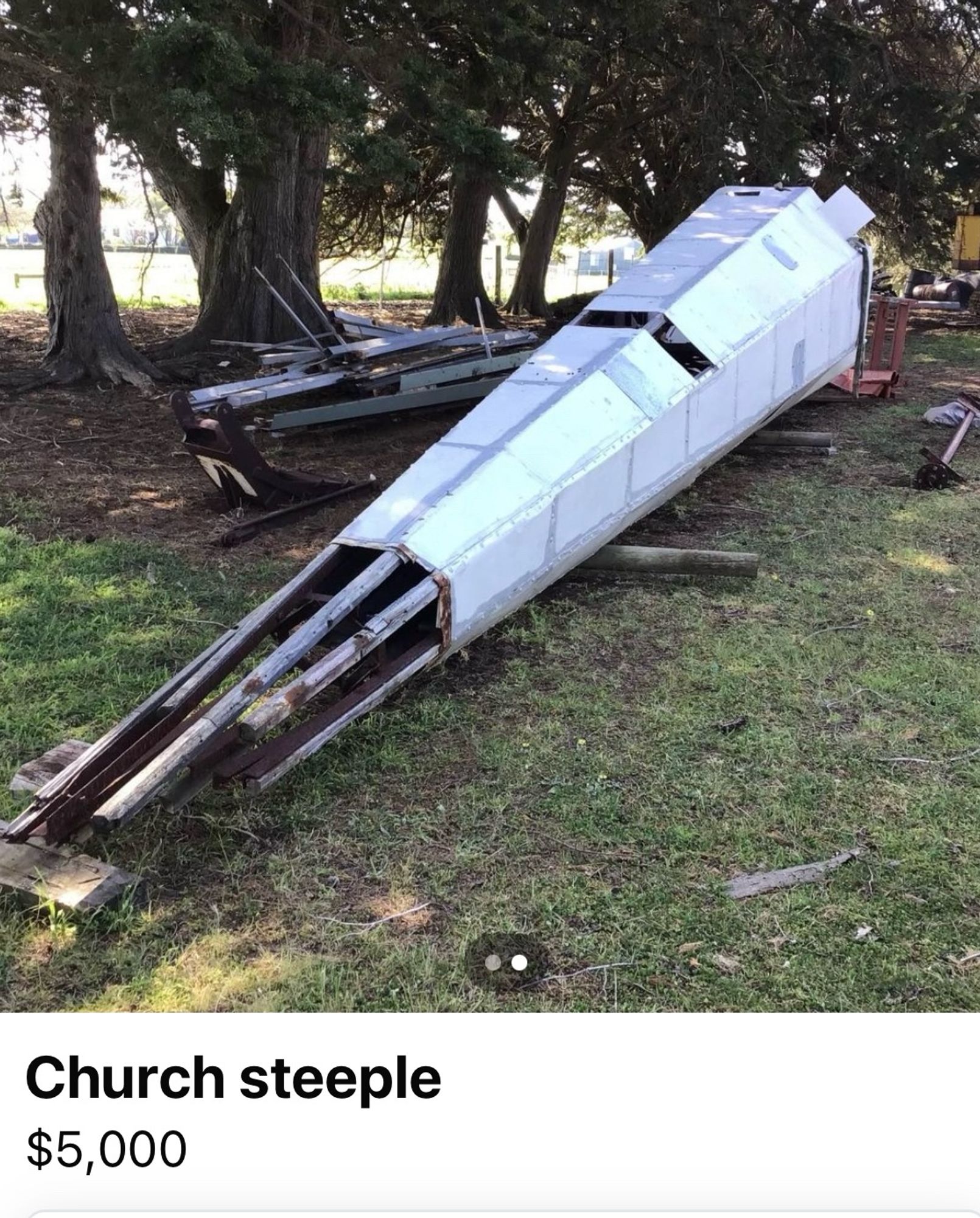 A church steeple lying on its side in a paddock