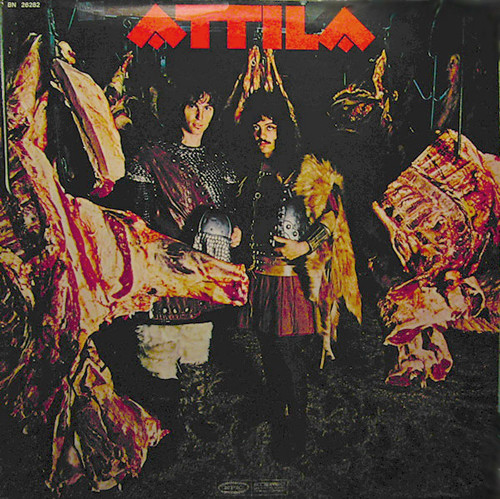 The front cover of prog metal band Attila's only album. Band members Jon Small and Billy Joel (yes, that Billy Joel) are wearing suits of armor, surrounded by large slabs of hanging meat.