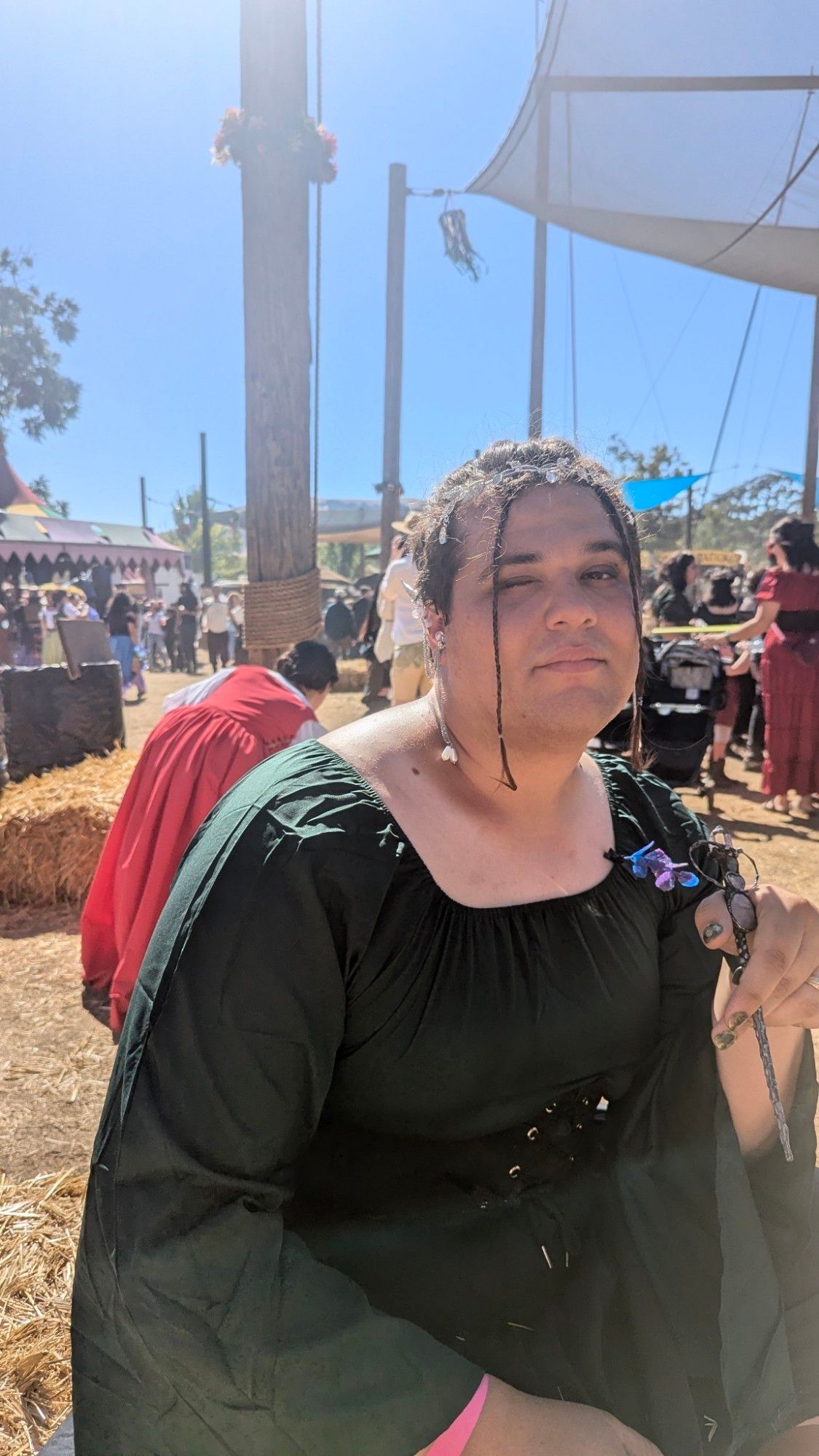 Me in a Renaissance dress with one eye open. The sun was right over us and I'm sitting down because I was tired.