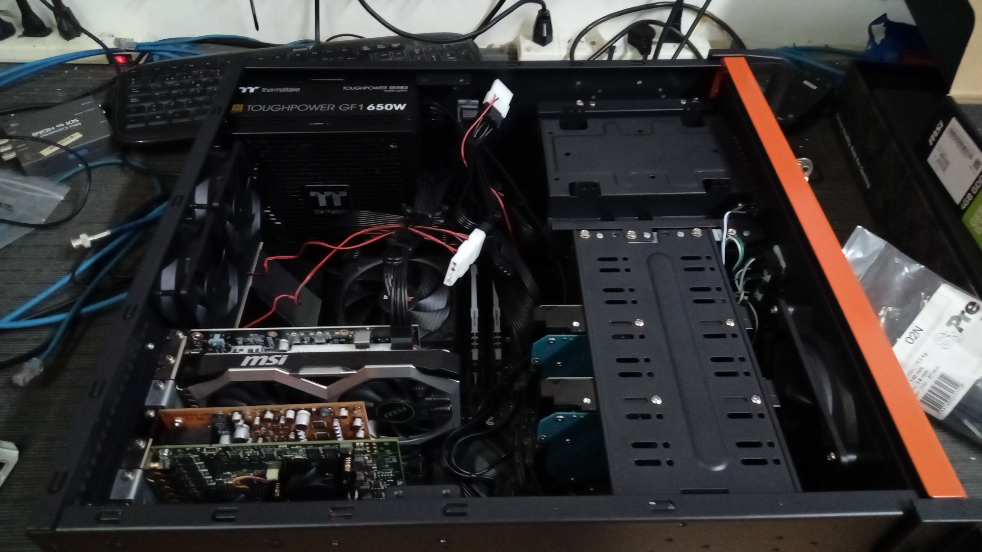 An open computer case, showing the internal devices