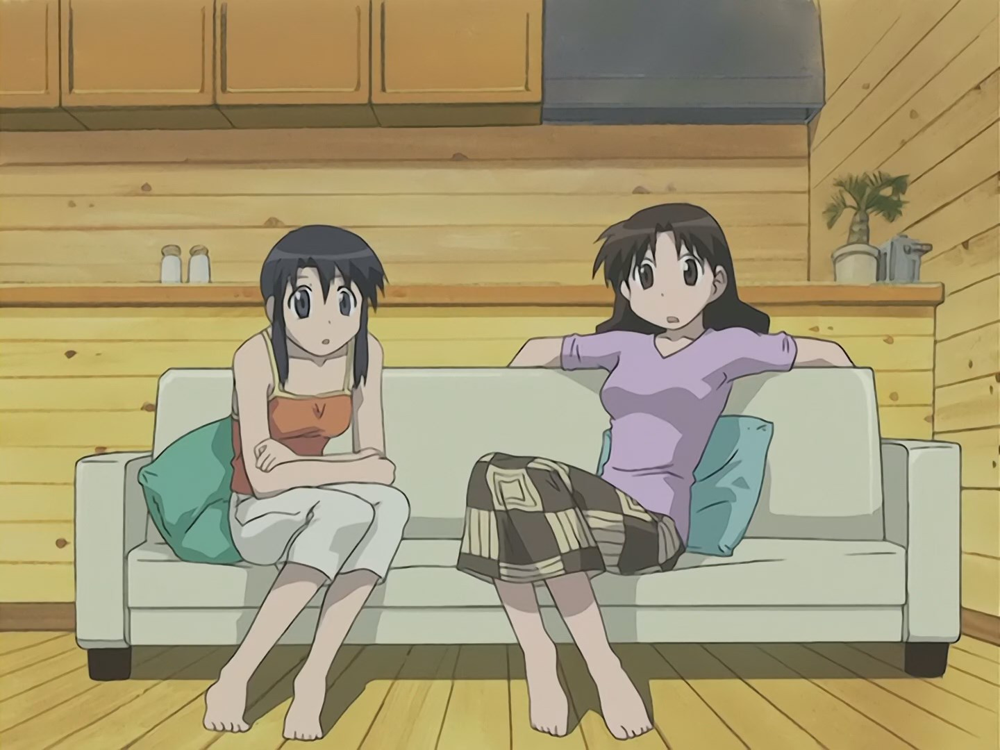 Yukari and Nyamo from Azumanga Daioh. Yukari is a tall lady with brown hair, brown eyes, a brown and tan dress and a purple shirt, sitting on a sofa with her arms dangling behind it. Nyamo has black hair, pewter eyes, wearing a orange tanktop with a white bottom. her arms are crossed and resting in her lap.