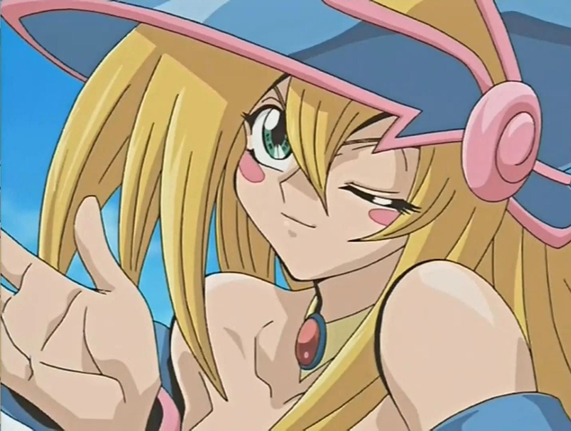 Dark Magician Girl from Yugioh, a blonde haired green-eyed woman with a blue hat with pink lining. She is winking at the camera, and her shoulders can be seen