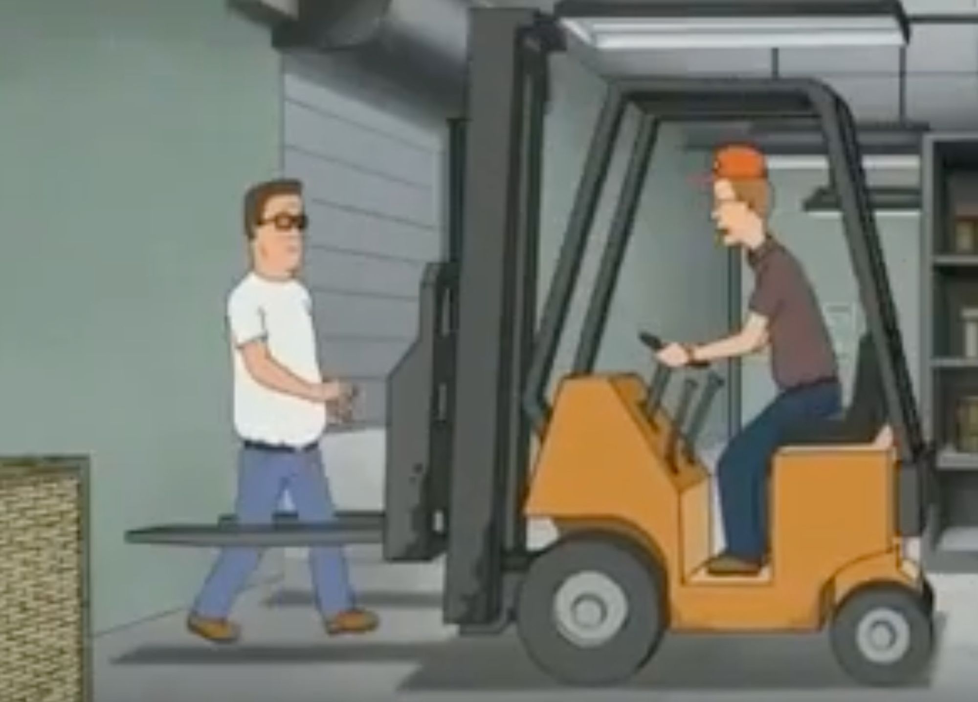 A screenshot of an episode of King of the Hill. Dale drives a forklift into a brick wall while Hank stands between the two forks.