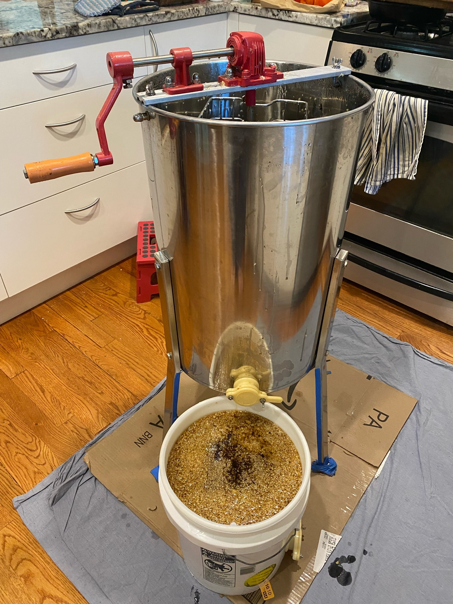 Honey extractor and a bucket for the honey to drain into