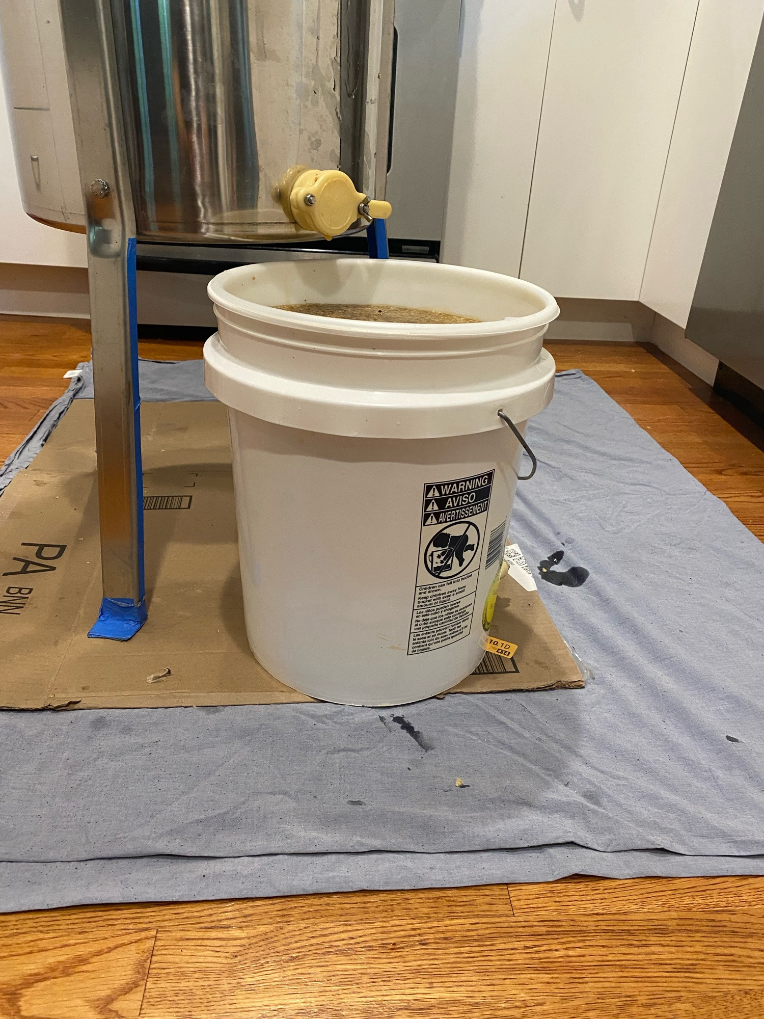 5 gallon bucket nearly full of honey