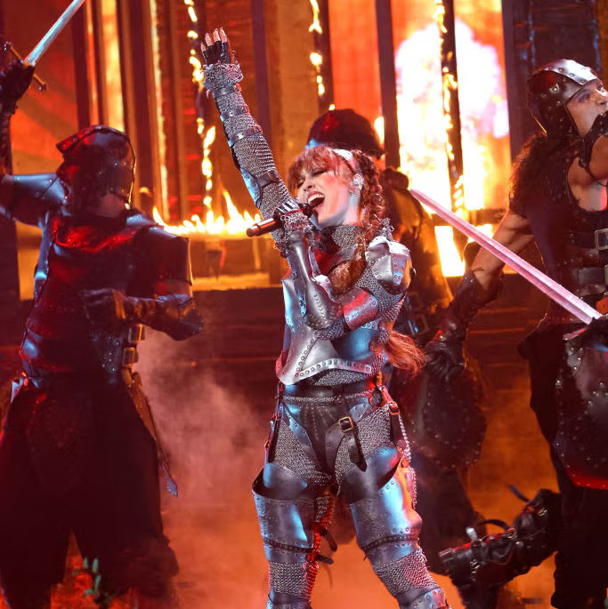 Artist Chappell Roan performs 'Good Luck Babe' at the 2024 VMA award, dressed as a knight while a castle burns behind her and soldiers do synchronized dance fighting.