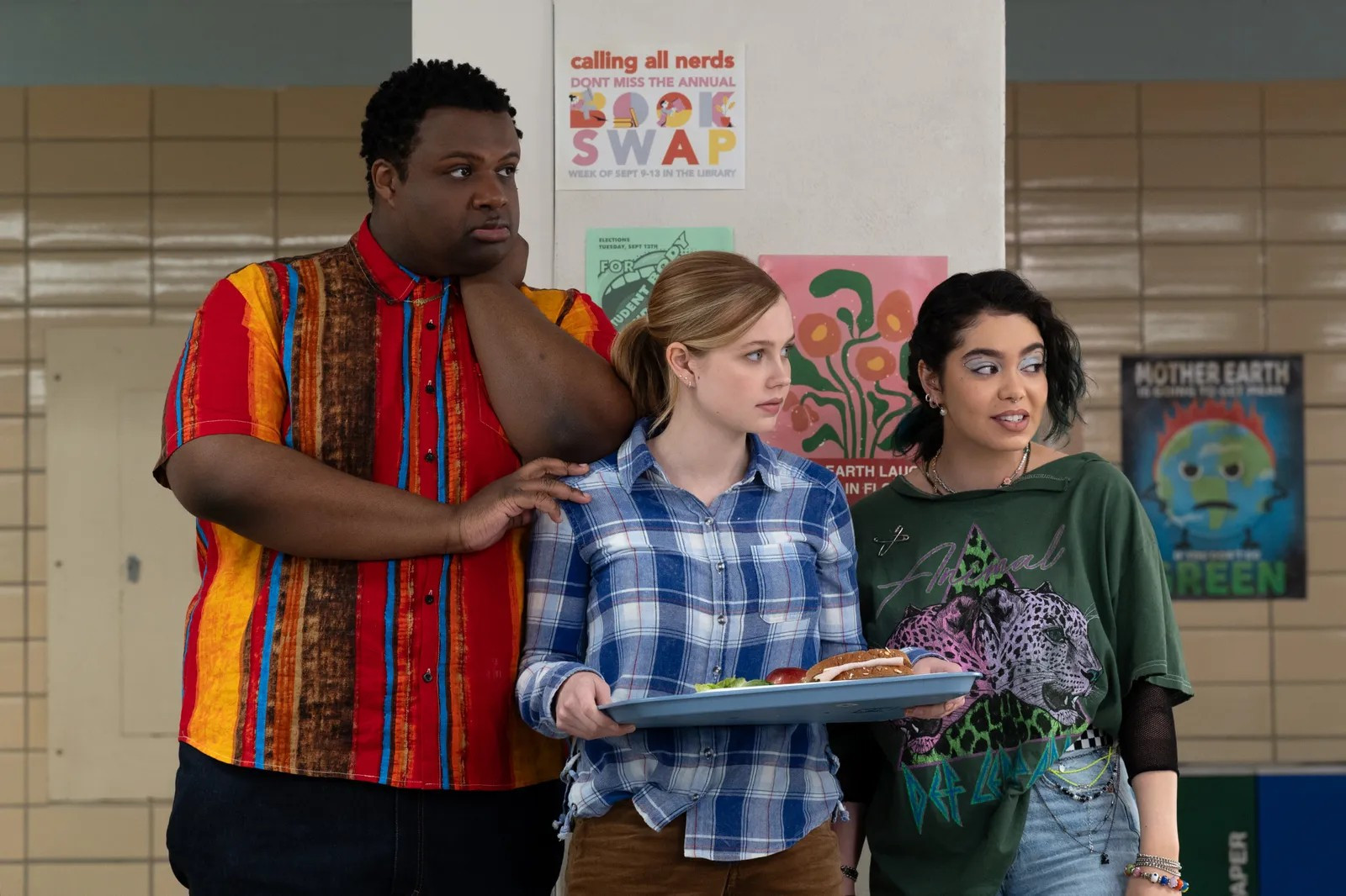 Jaquel Spivey, Angourie Rice and Auli'i Cravalaho in Mean Girls. Spivey is a tall black man, Rice is a shorter, intensely worried looking white woman and Cravalho is a taller woman of colour with amazing eyeshadow.