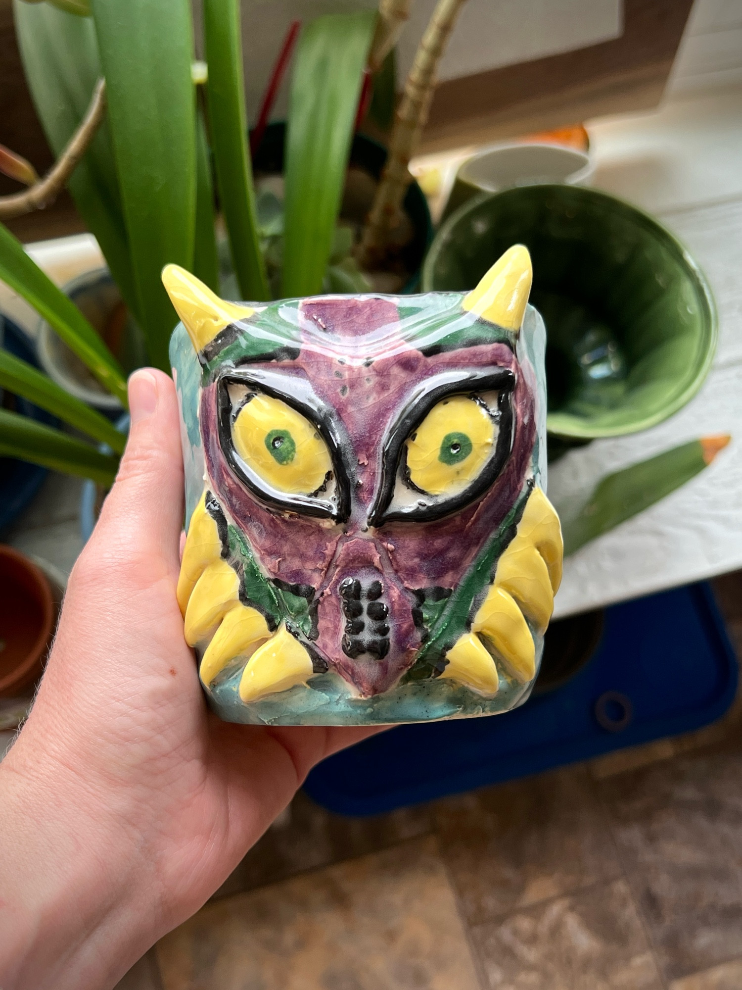 Very goofy looking handmade flower pot made to look like Majora’s mask.