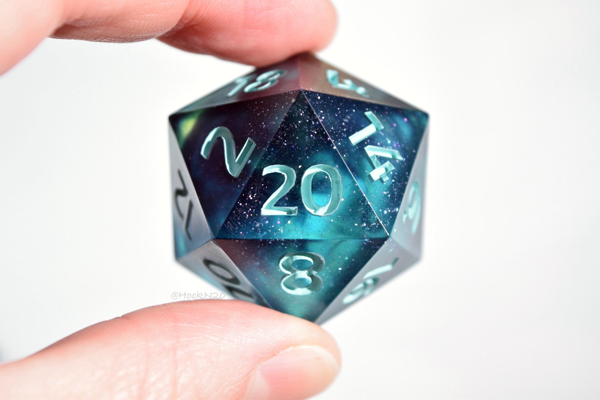 A jumbo d20 I made inspired by the film The Abyss. It’s dark and swirling with teal and micro glitter shimmer. Literally my favorite!