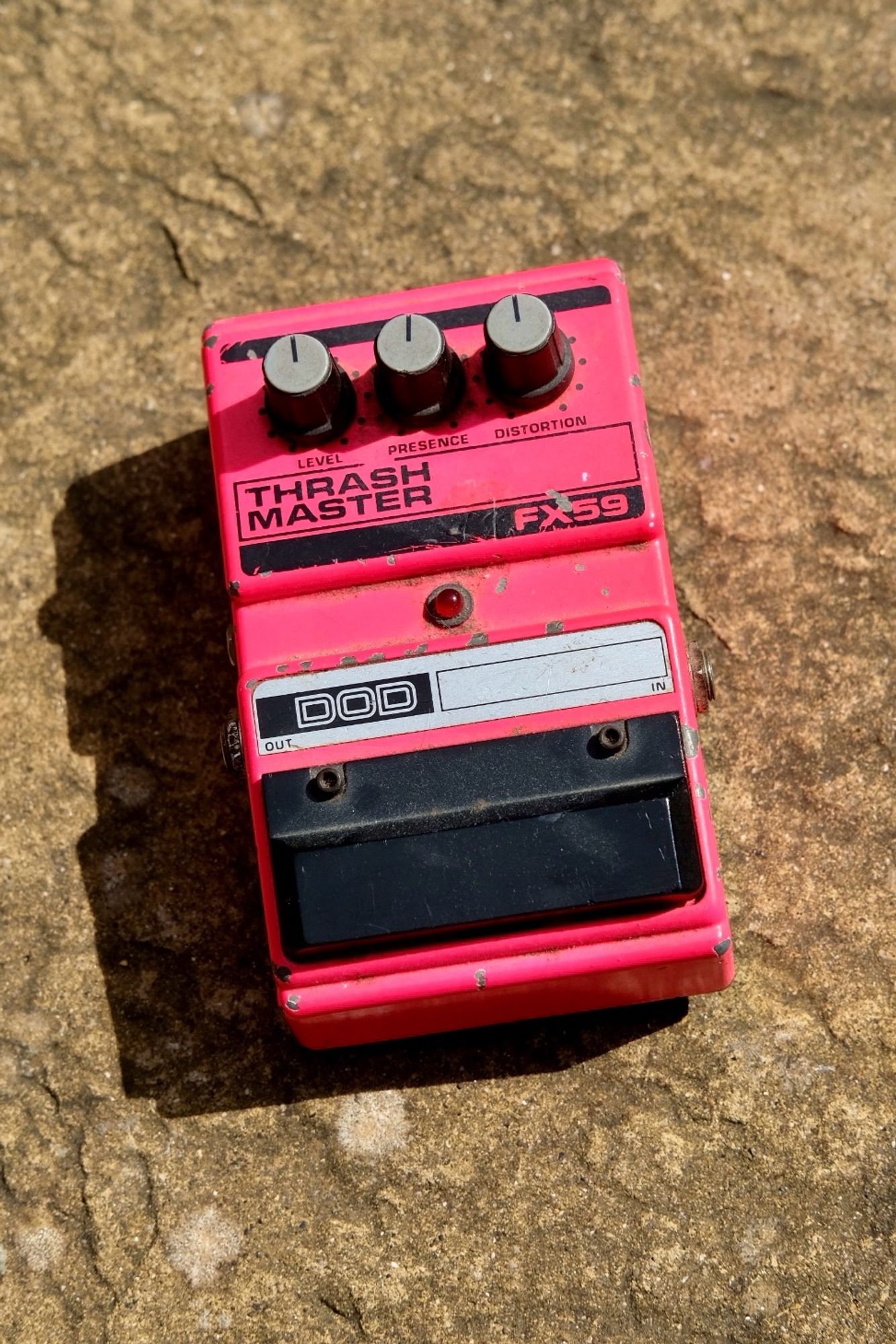 DOD Thrash Master guitar pedal in shocking pink with three control knobs and a black foot switch