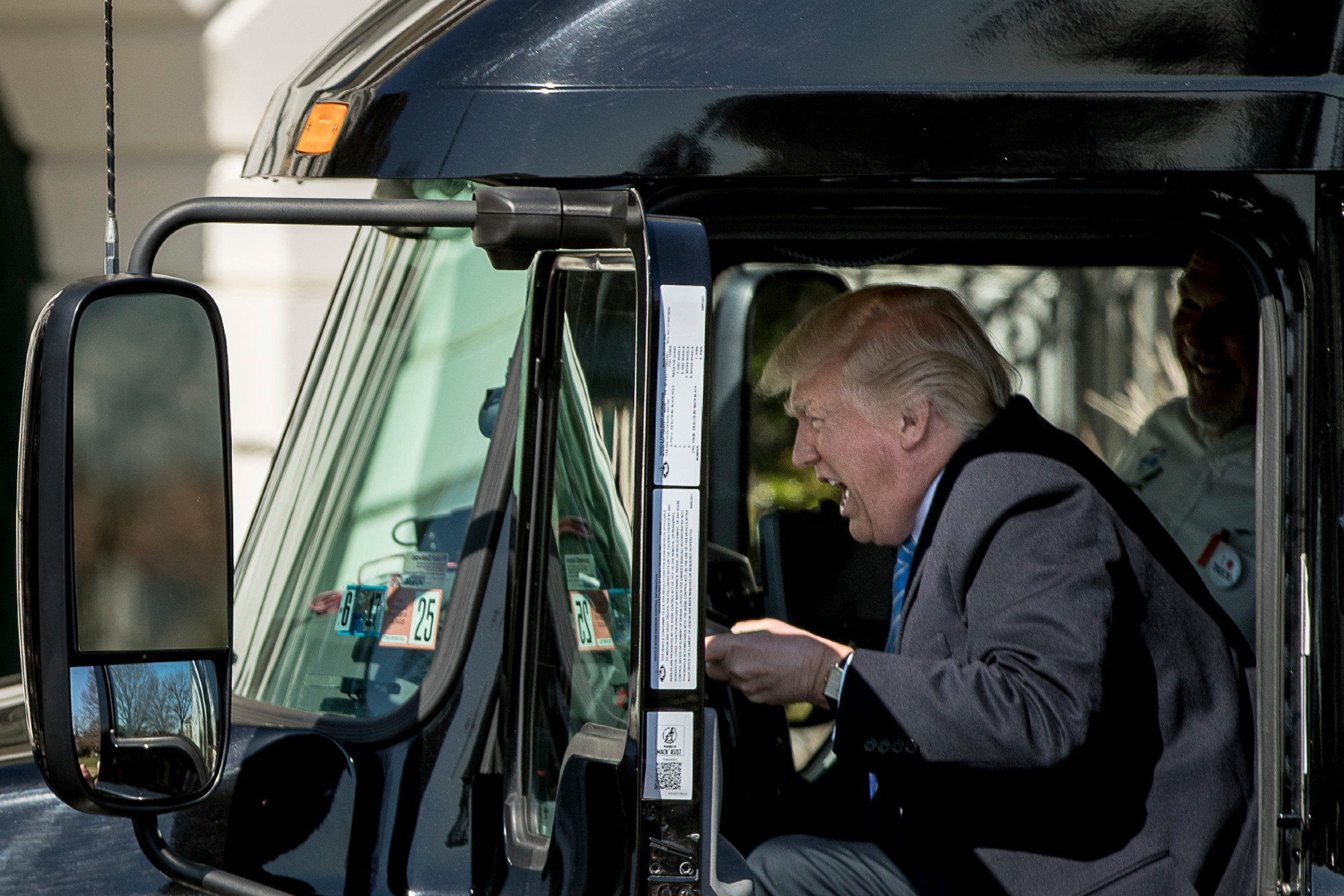 Photo: An infamous photo opportunity featuring the 45th President of the United States, Donald Trump, sitting behind the steering wheel of a tractor trailer truck during a 23 March, 2017 event at the White House. It was part of an event for the American Trucking Association. The photo is frequently featured as rife for satire thanks to the peculiar, grimacing expression that the former President made while pretending to steer the vehicle.