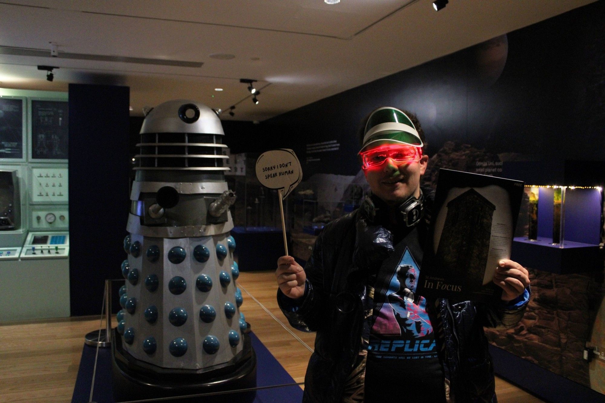 Man with Dalek in a cyberpunk costume.