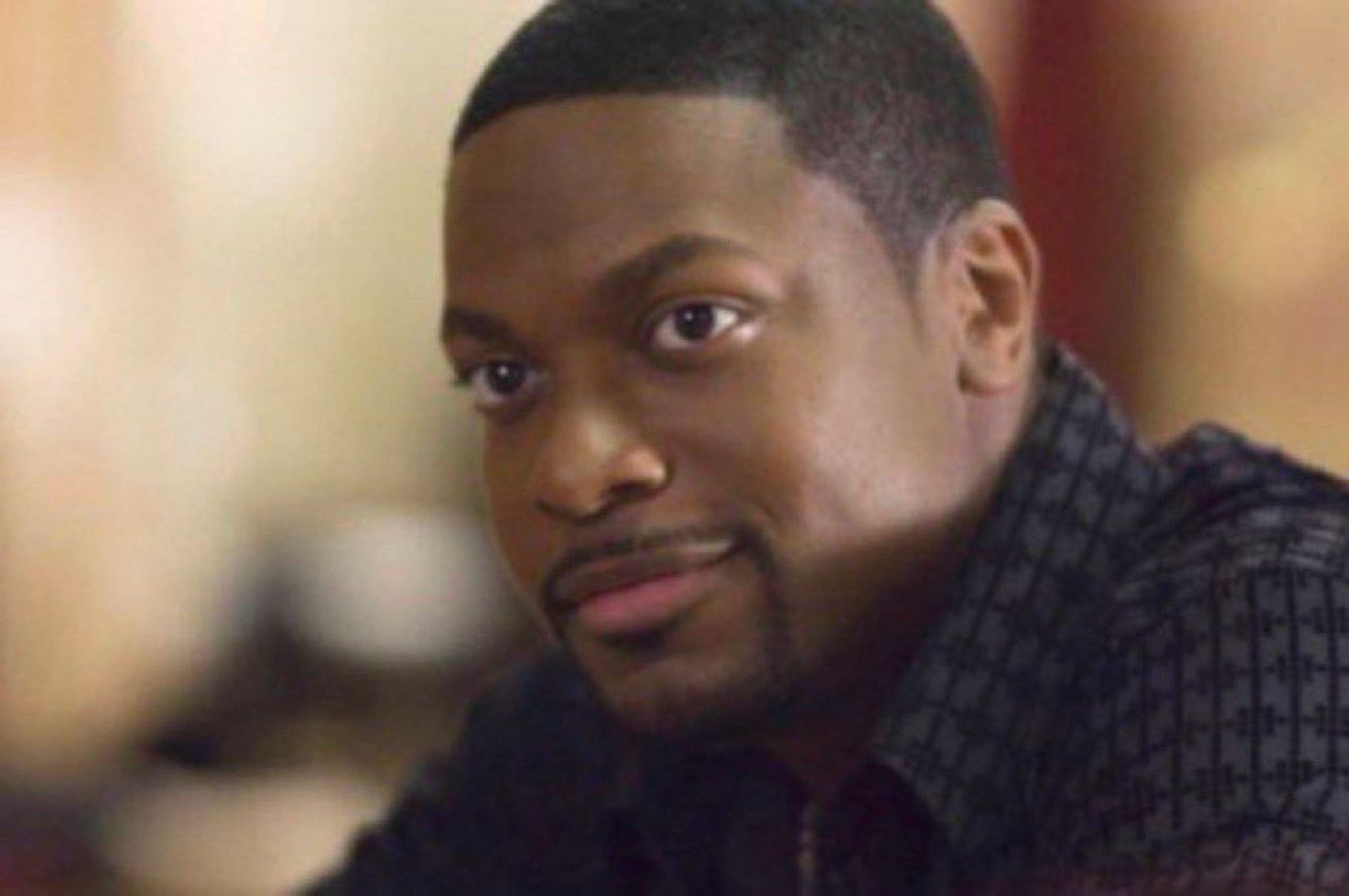 An image of Chris Tucker with a wide smile on his face.