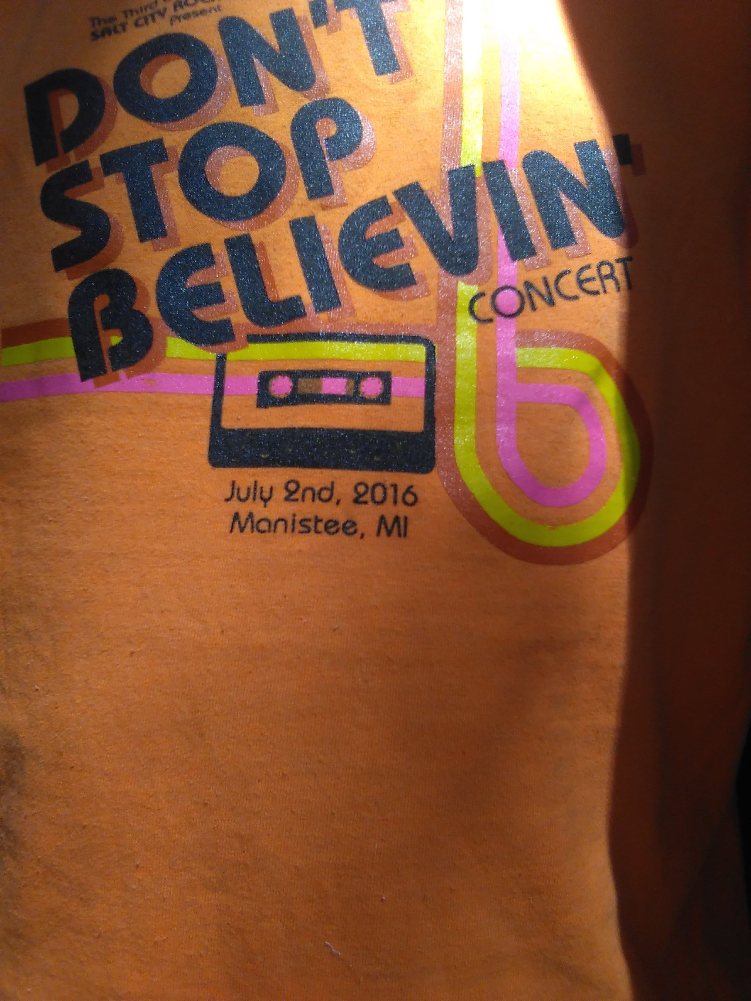 Orange swag tee from Journey cover band show, "Don't Stop Believin" concert with image of cassette tape beneath. July 2nd 2016 Manistee , MI
