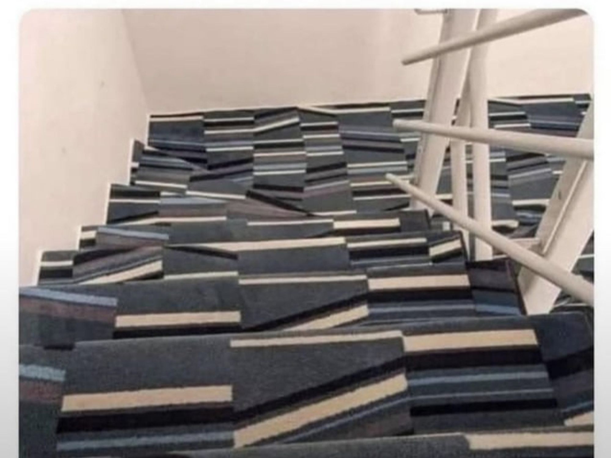 Looking down the stairs with a crazy crooked carpet design