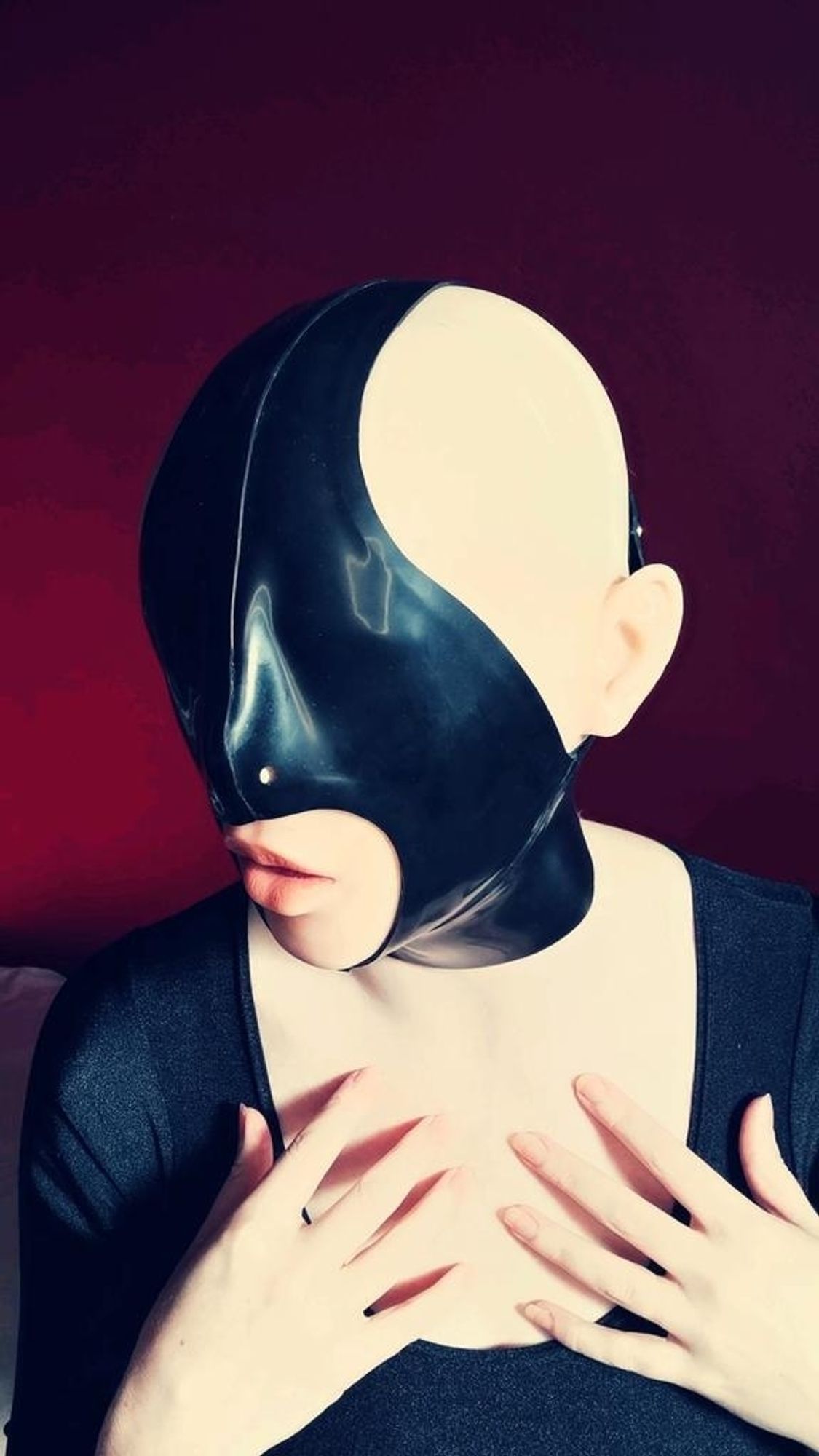 A thick rubber blindfold that covers most of the face except the mouth and back of head.