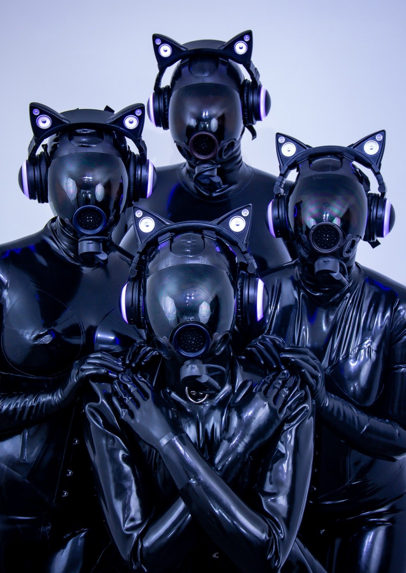 Four almost identical latex drones in black catsuits, msa Millenium gas masks and cat ear headphones