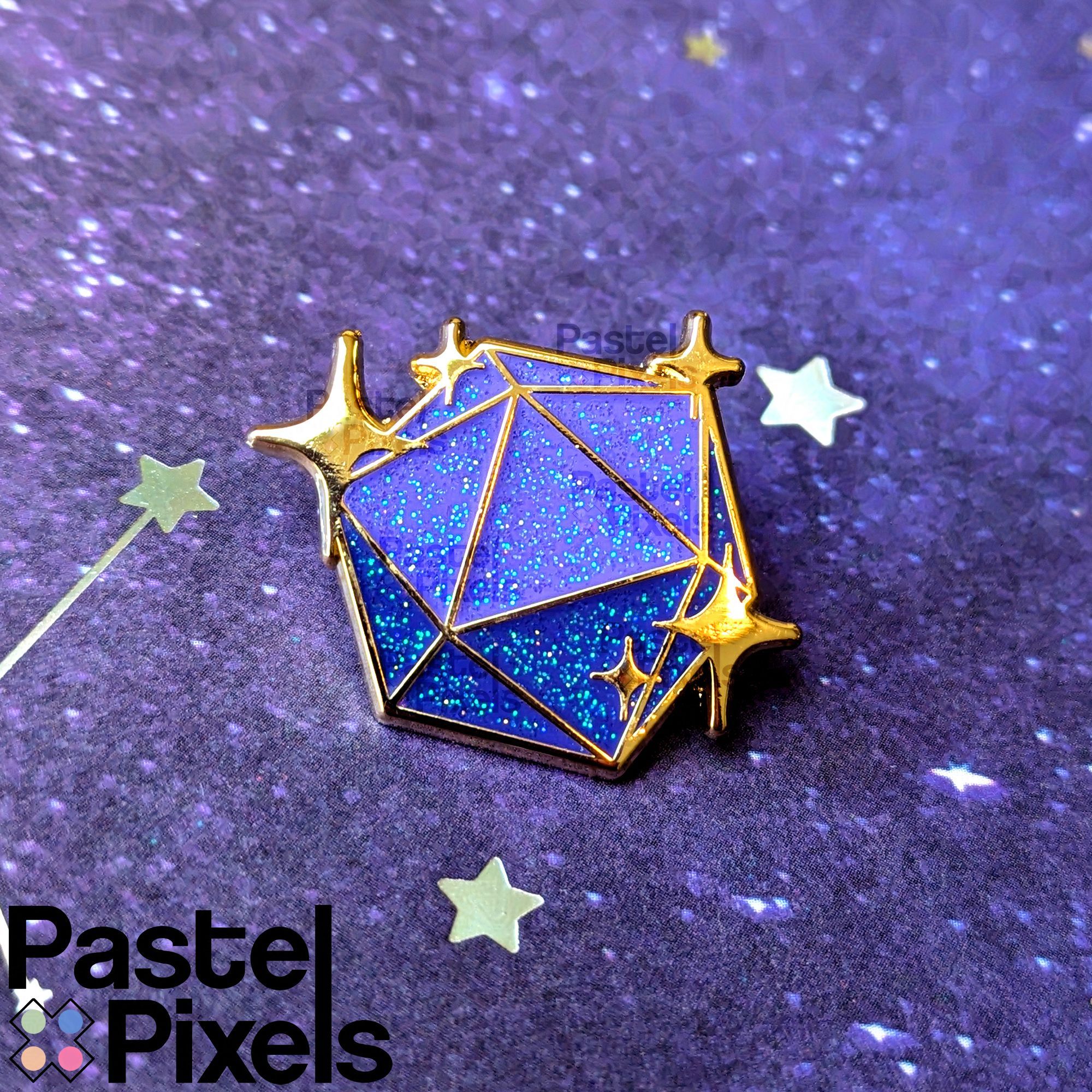 A gold plated enamel pin, of a D20 with sparkles around it. The pin has purple enamel with various shades of glitter in the enamel