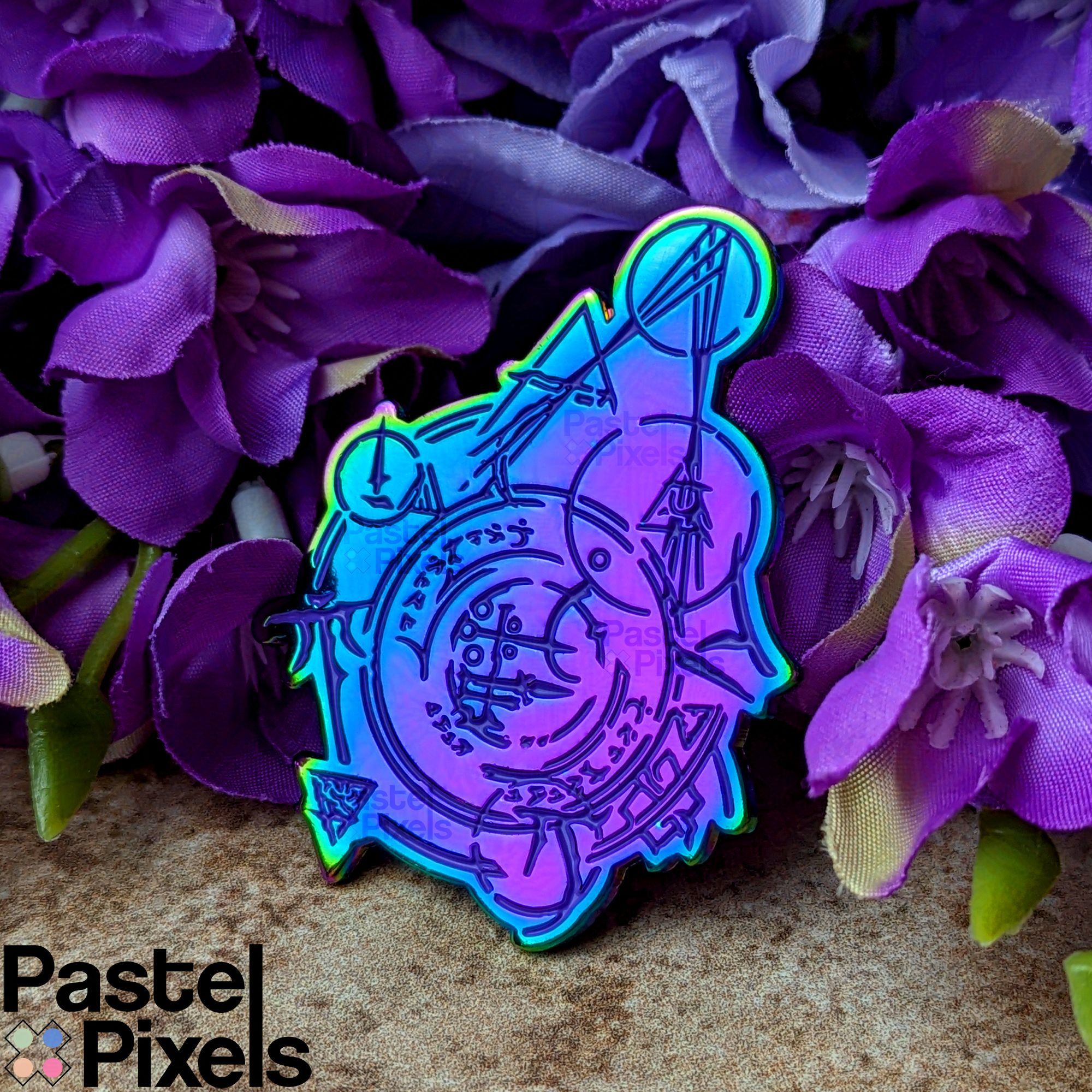 An enamel pin of the fast travel waypoint runes from BG3. The pin has  rainbow metal, so the pin features a lovely purple, to blue, to turquoise gradient. 
The pin sits propped up against a bed of fake wisteria flowers.