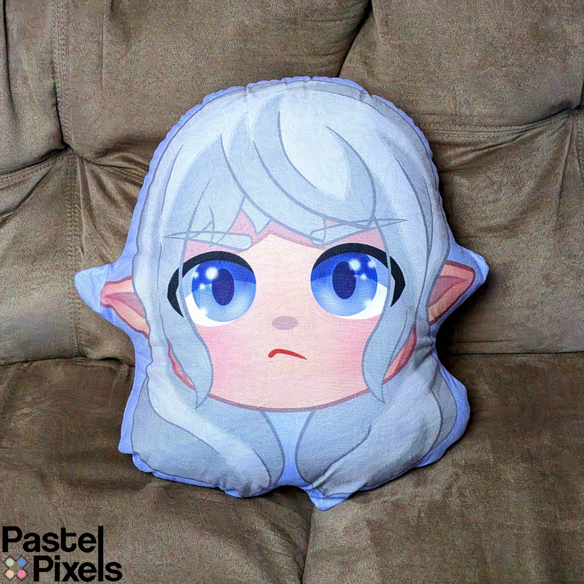 An adorably grumpy illustration of Estinien, that's been turned into a pillow