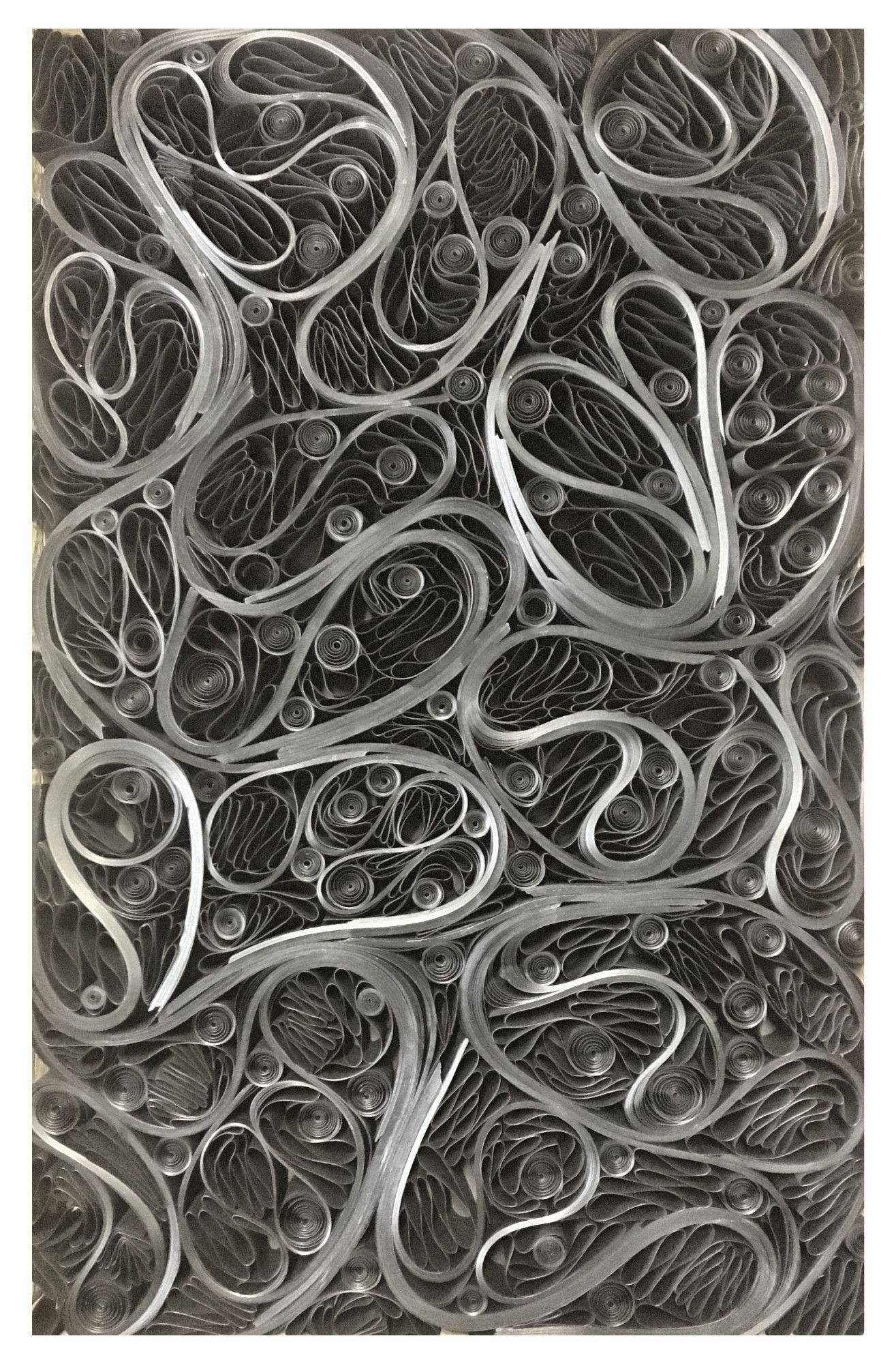 Paper folded and curved into a flowing abstract design.