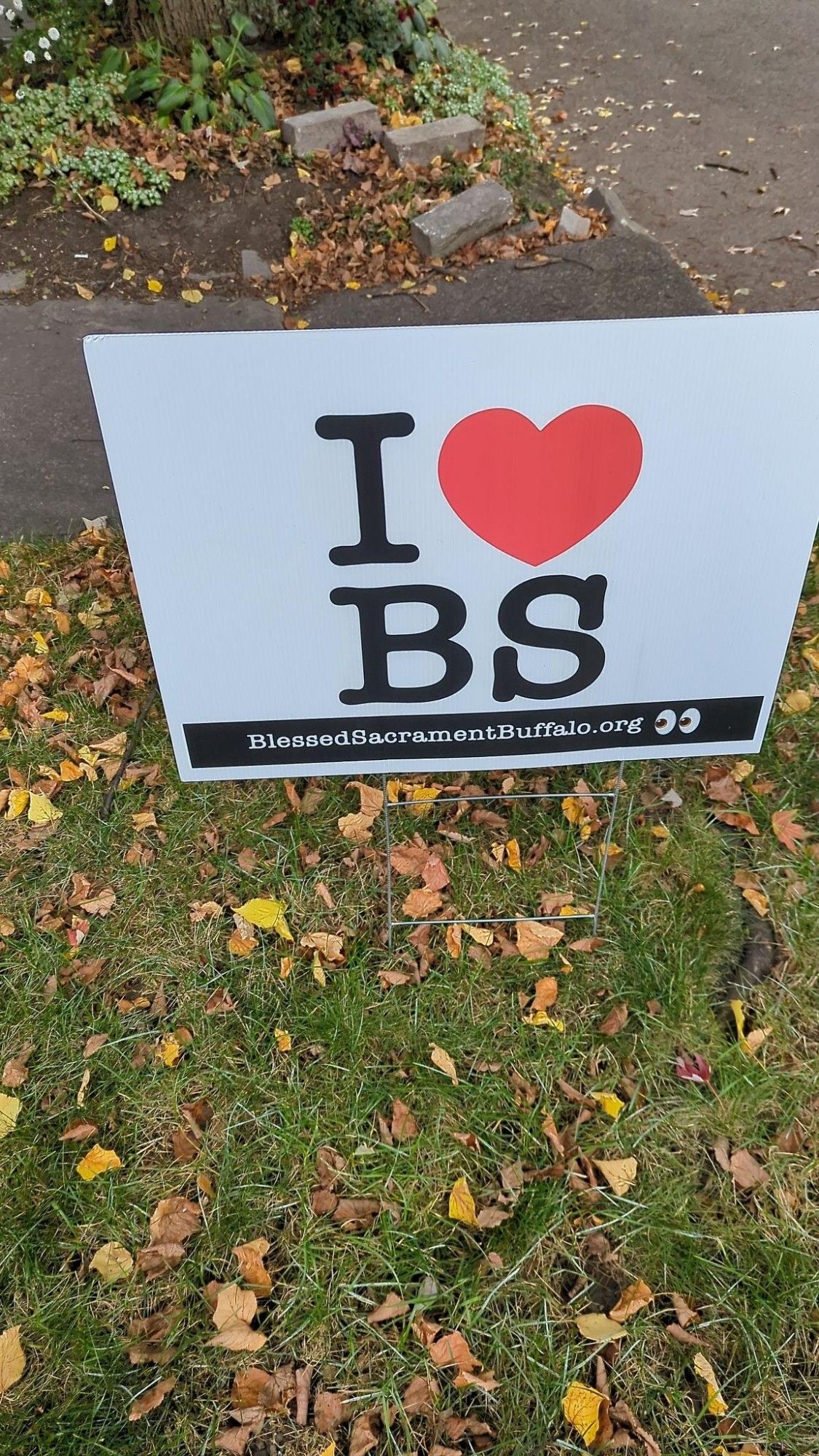 Lawn sign reading "I ❤️ BS" and then below, smaller, "blessed sacrament Buffalo.org" which is a Catholic church.