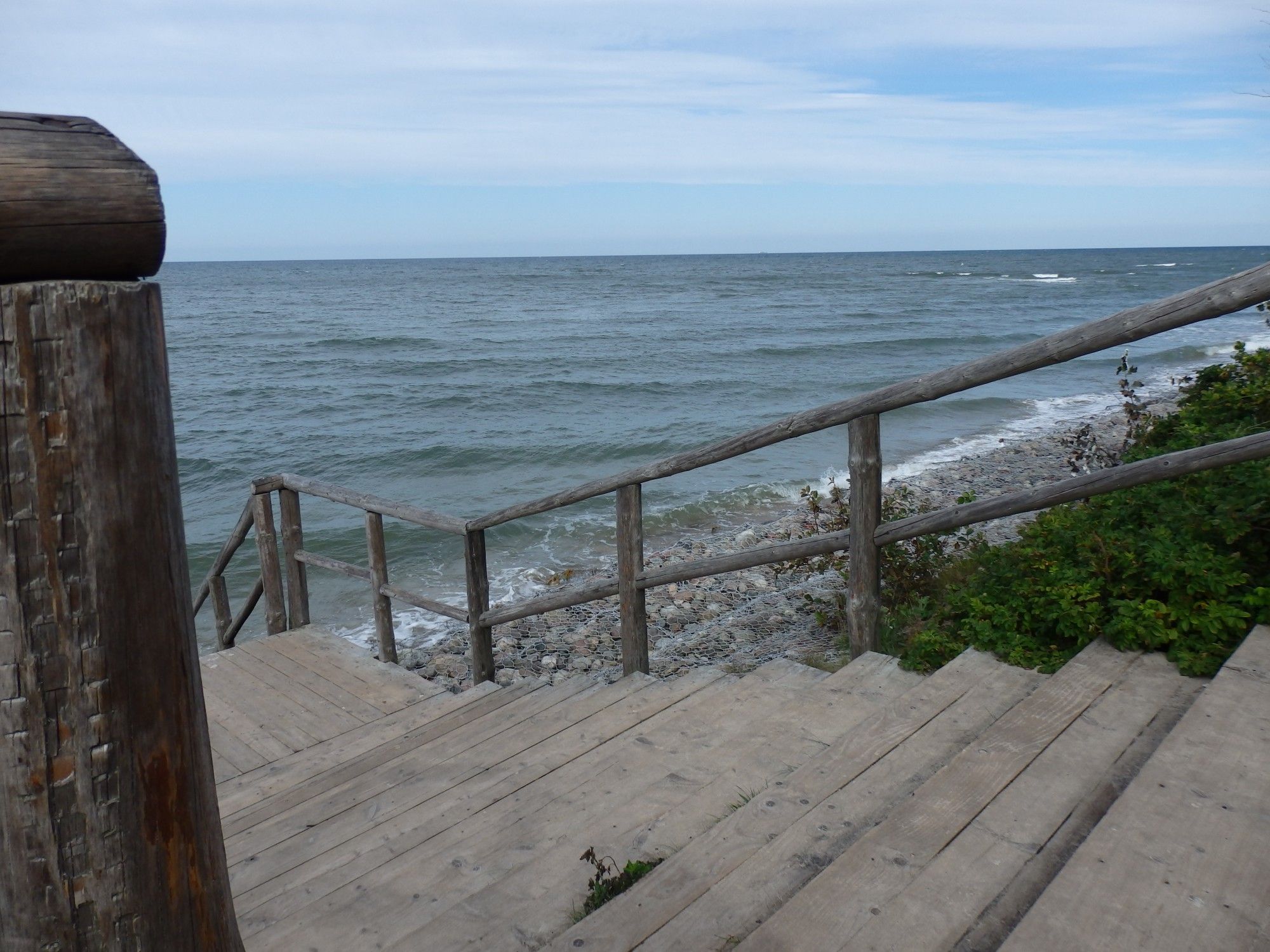 Wooden stairs down to the rocky part of Baltic shore