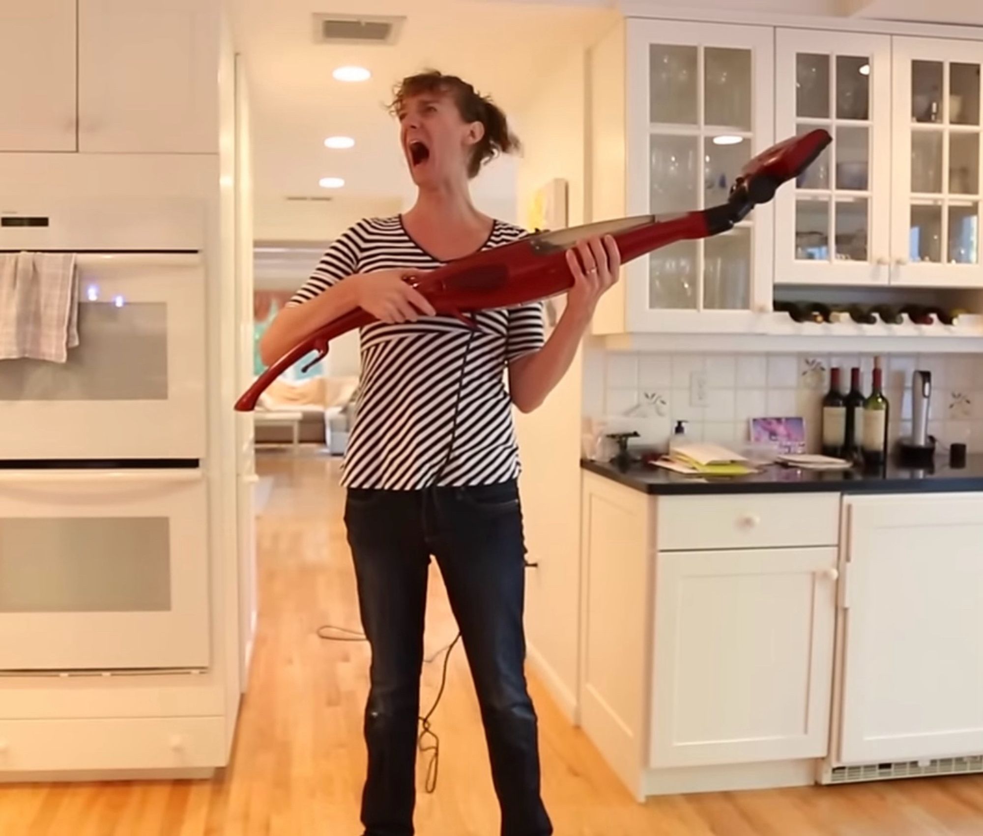 Chris Fleming holding a vacuum and yelling