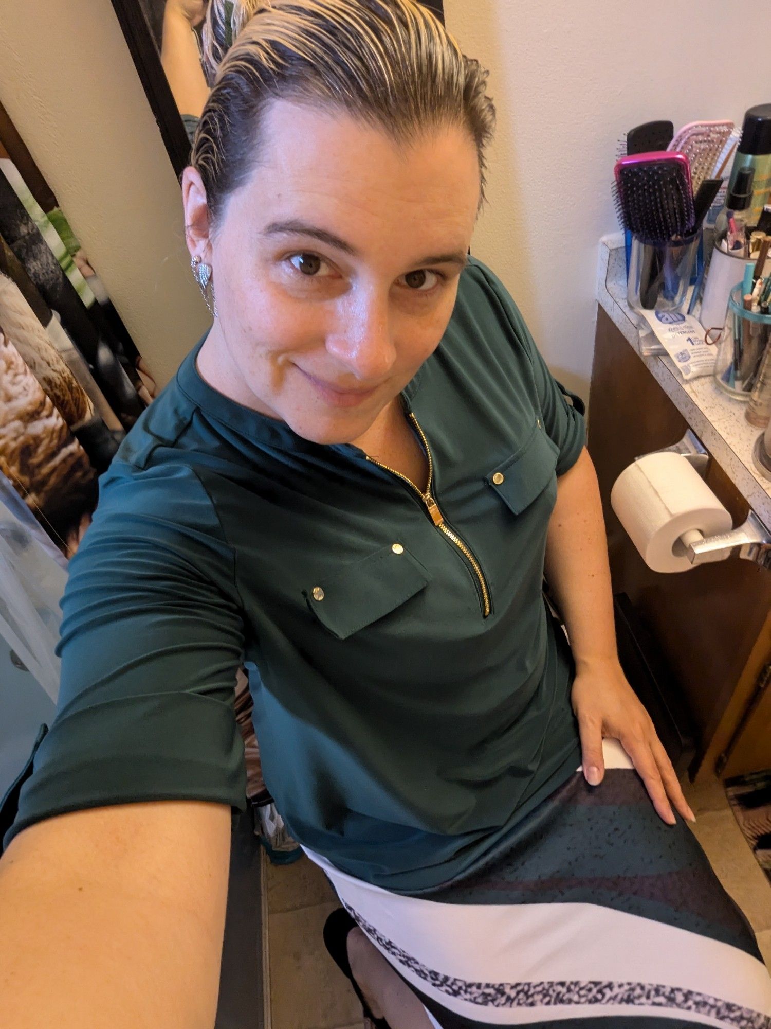 Me in a green shirt, my hair pulled back with a green hair clip, with a marbled white and green skirt that also has a part mimicking granite.  I have a smile on my face.