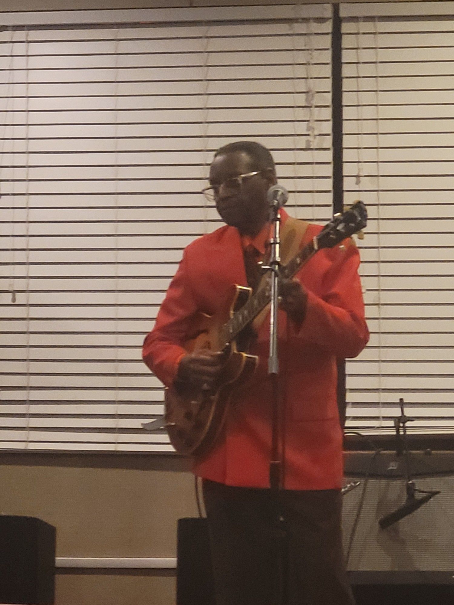 Man performing in a red coat