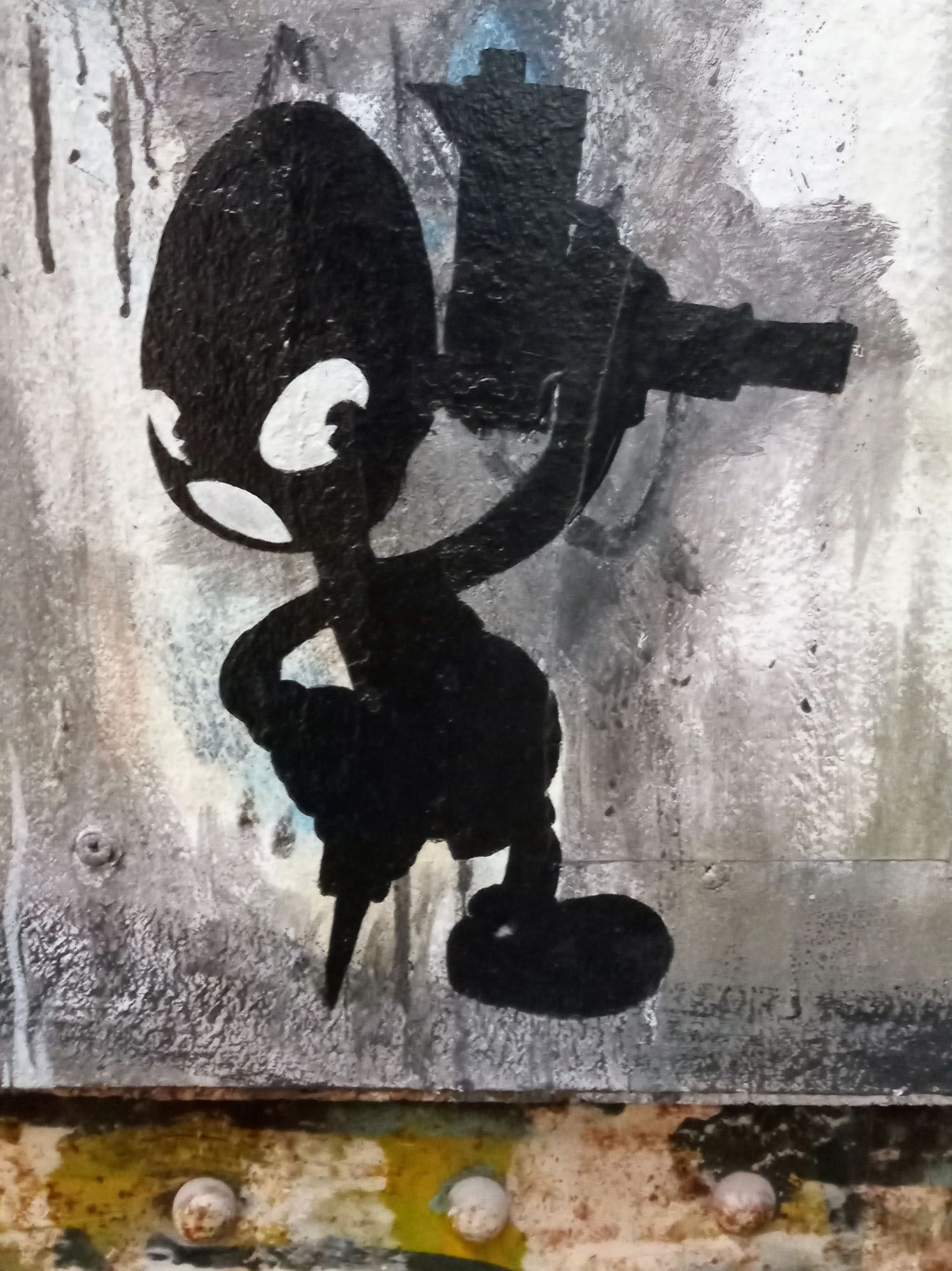 Black graffiti of a comic figure with one wooden leg and a pistol in his hand