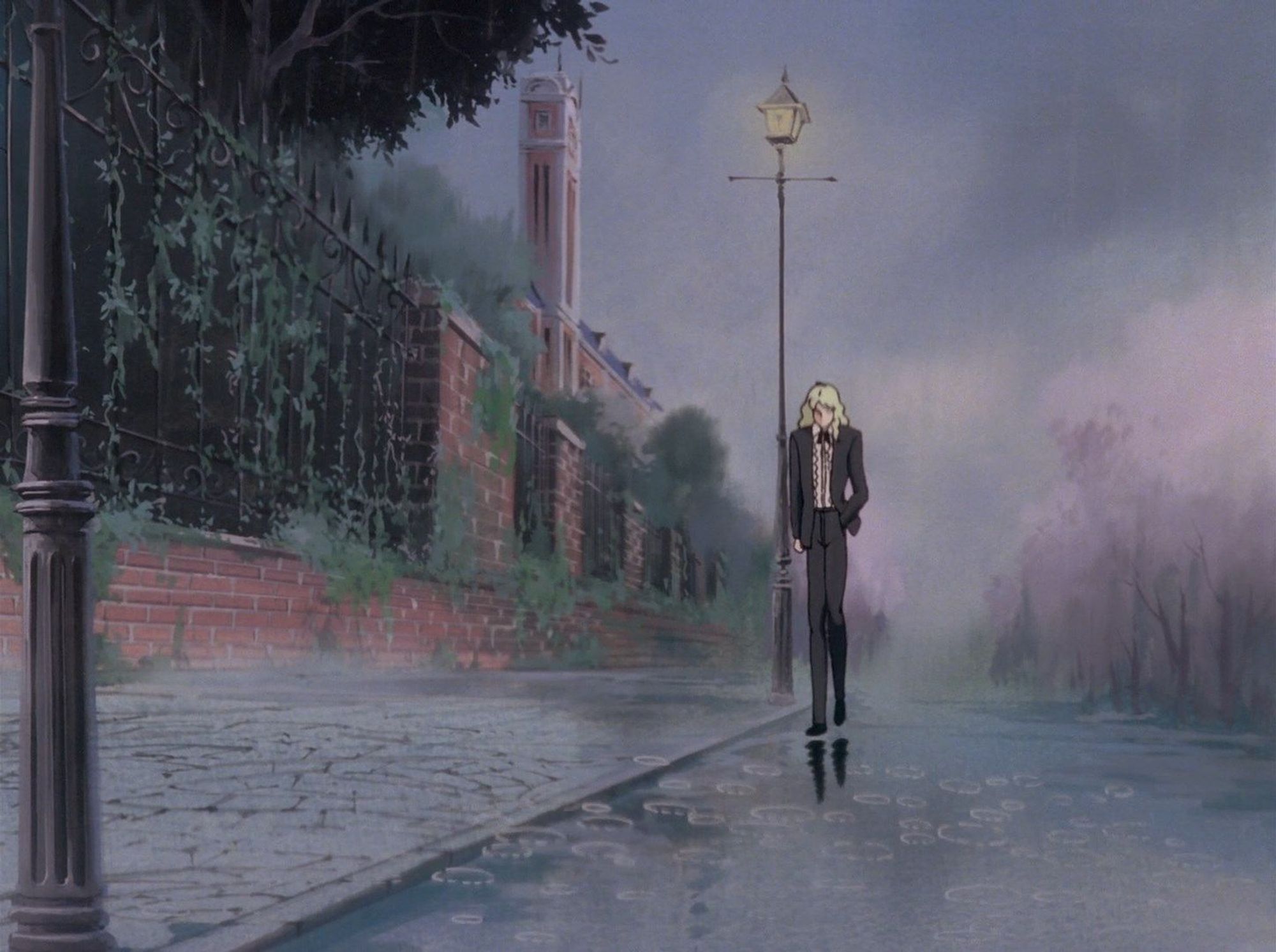 oniisama e... episode 1 screenie. wide shot of an empty street in the late afternoon, it's raining and asaka rei is standing there all alone