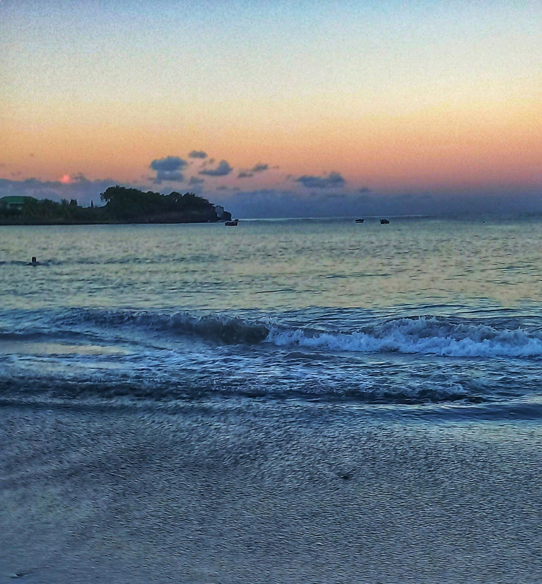 Image take from the shore. You can see the outline of some taking an early morning sea bath