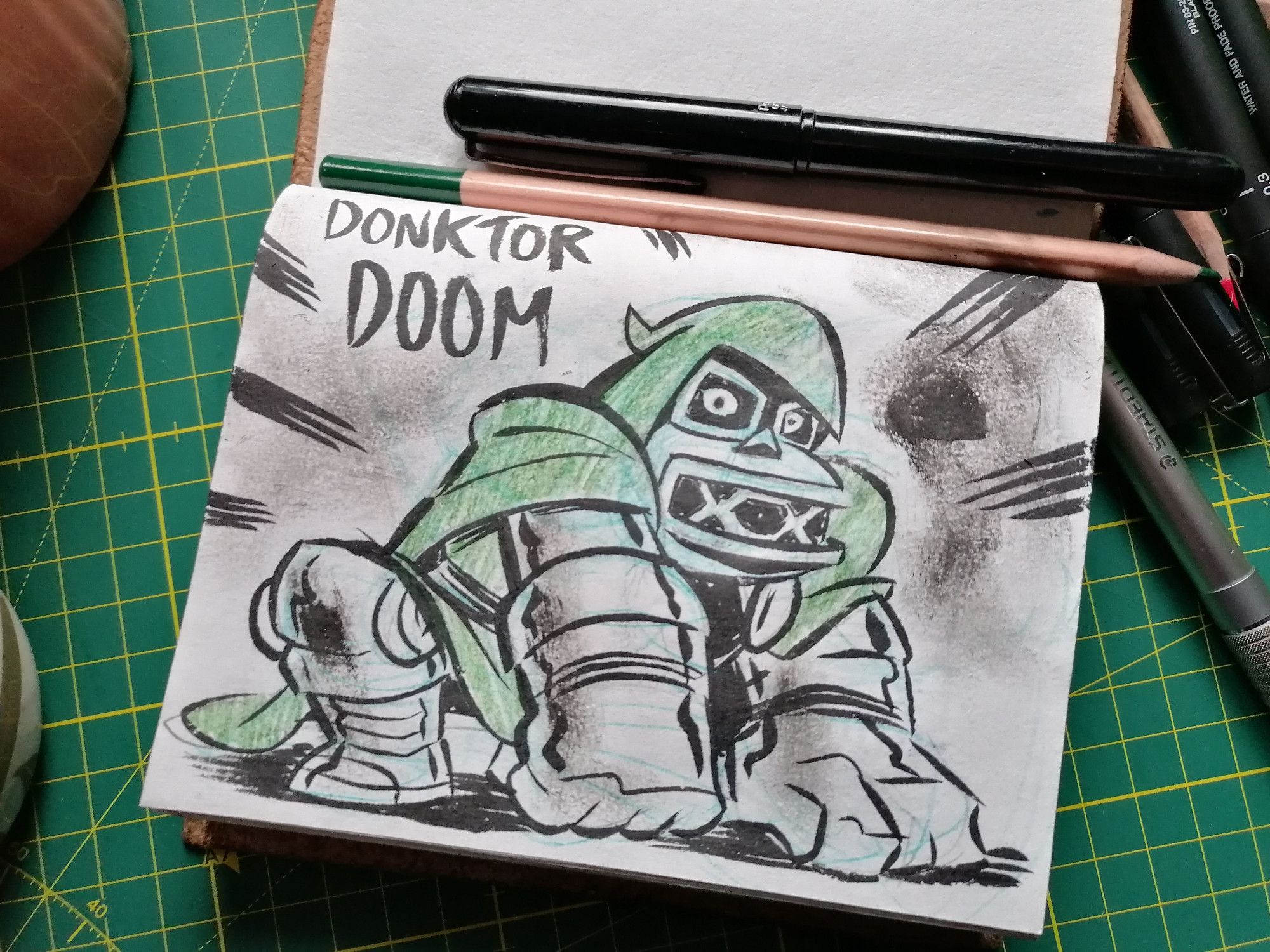 An open sketchbook, with a picture of Donkey Kong dressed up in Doctor Doom's attire.

Some call him... DONKTOR DOOM