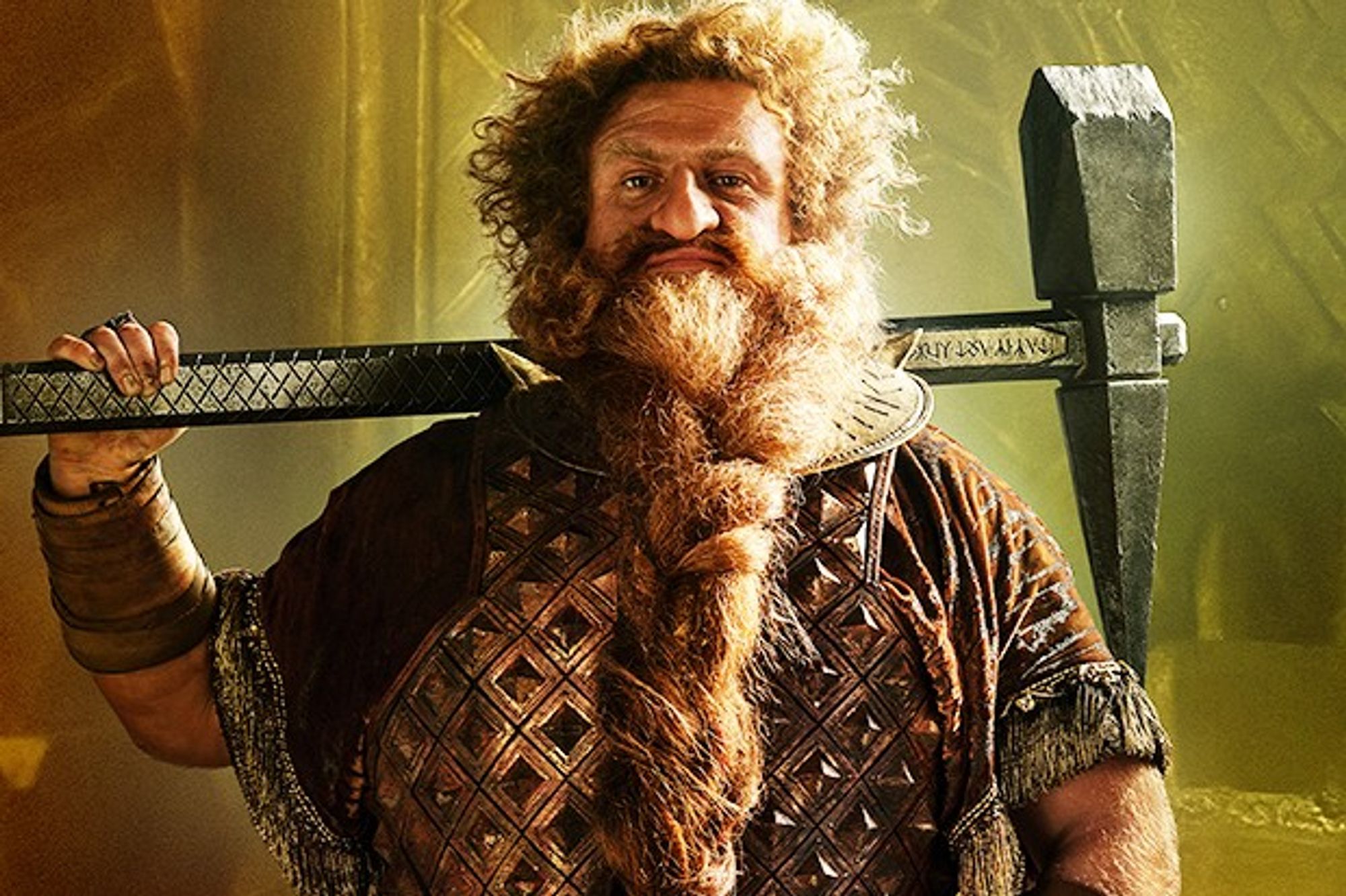 Prince Durin (Owain Arthur) from The Lord of the Rings: Rings of Power, a sturdy dwarf with a red plaited beard and a huge pickaxe carried over his shoulder