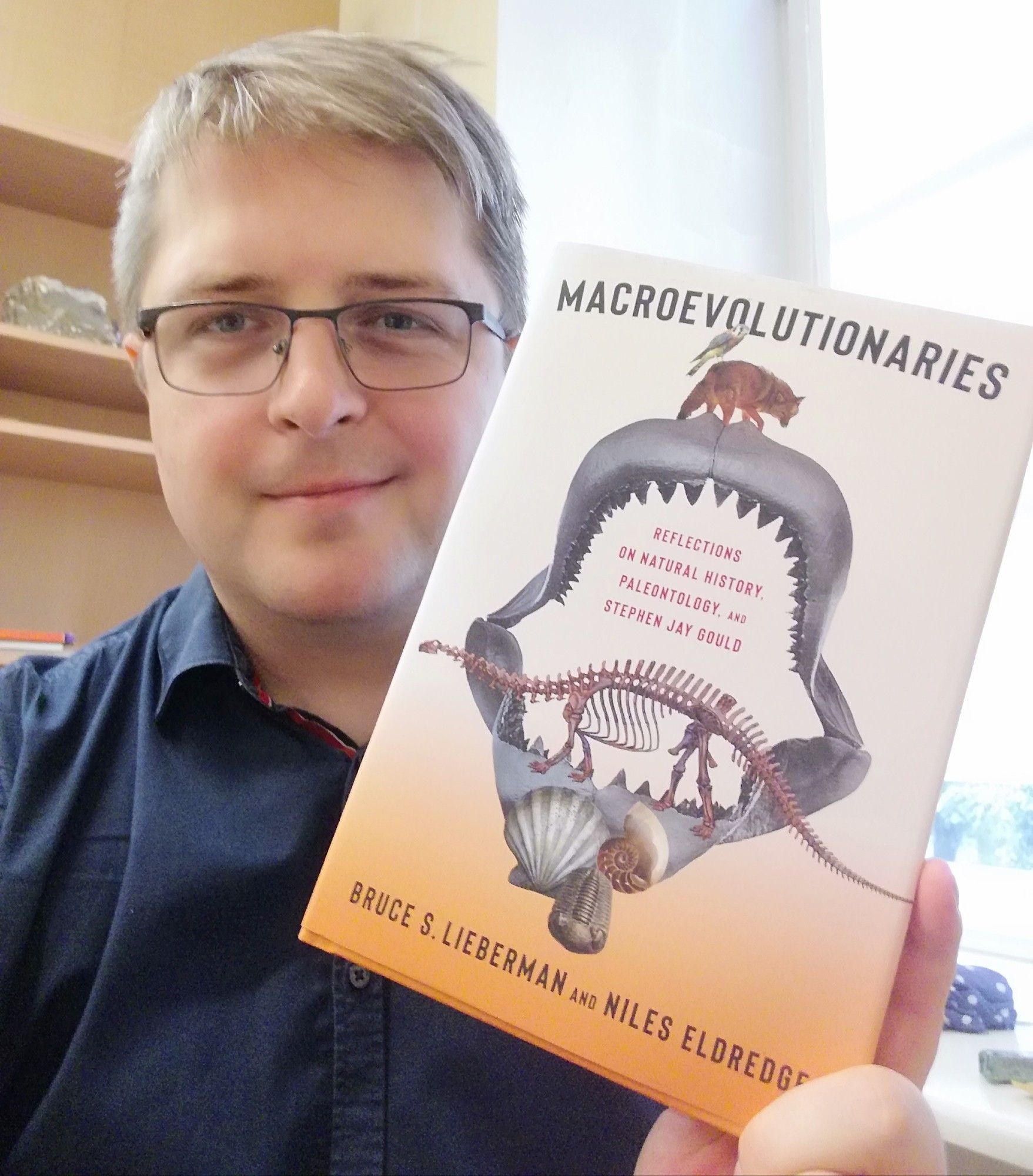 Andrej holding "Macroevolutionaries" book