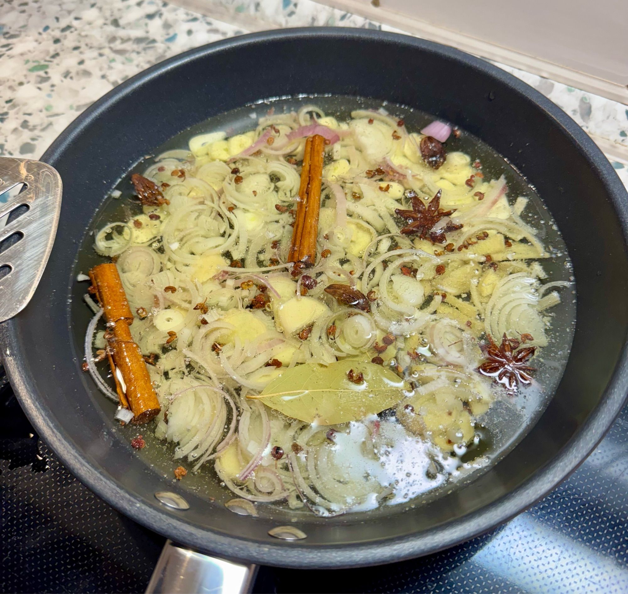 A pan with hot oil and spices