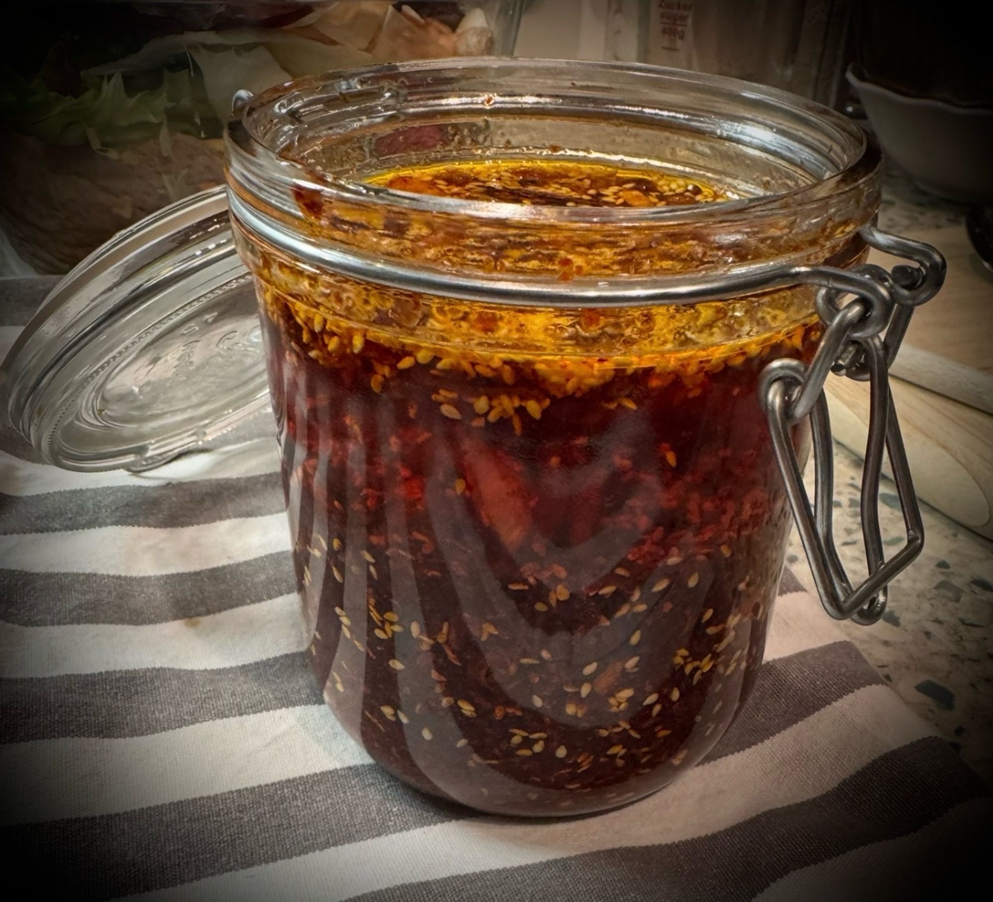 a glas with home-made spicy chili oil with crispy bits