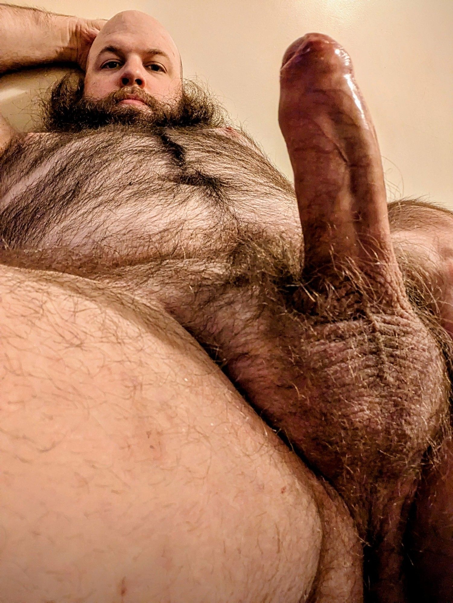 Photo of me from below of me laying down with my erect penis up front