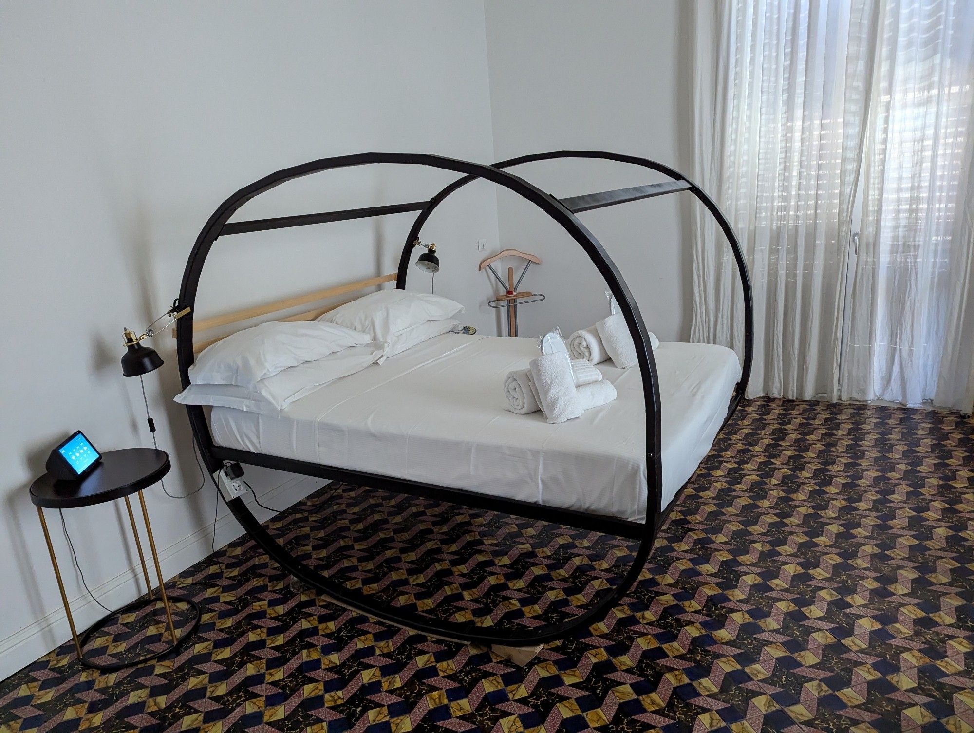 Photo of a bed suspended within a wheel bedframe