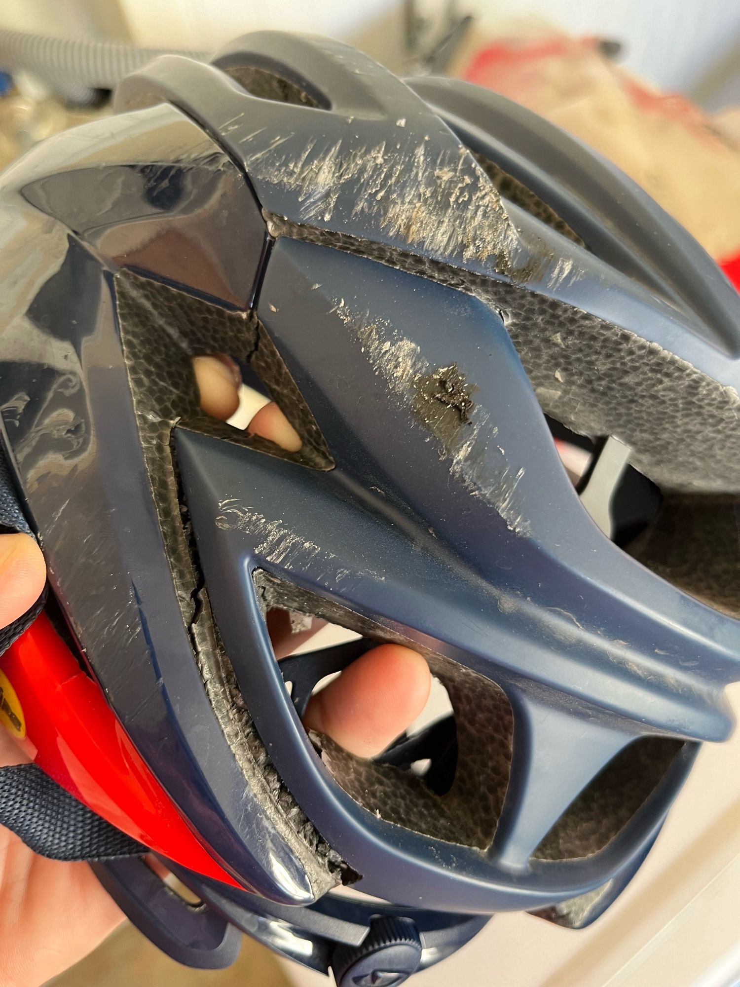 A cracked and scraped bicycle helmet